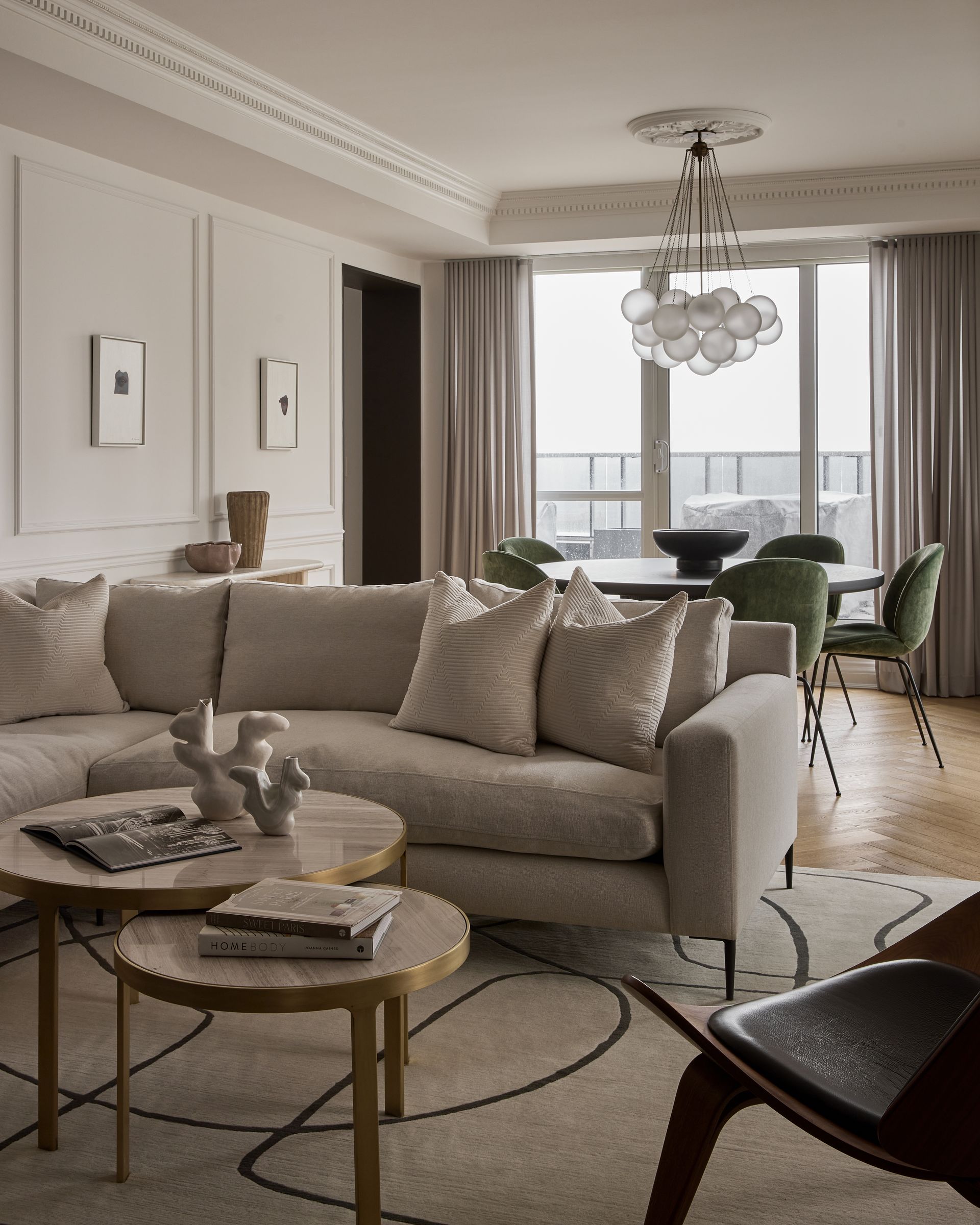 A living room with a couch , table and chairs