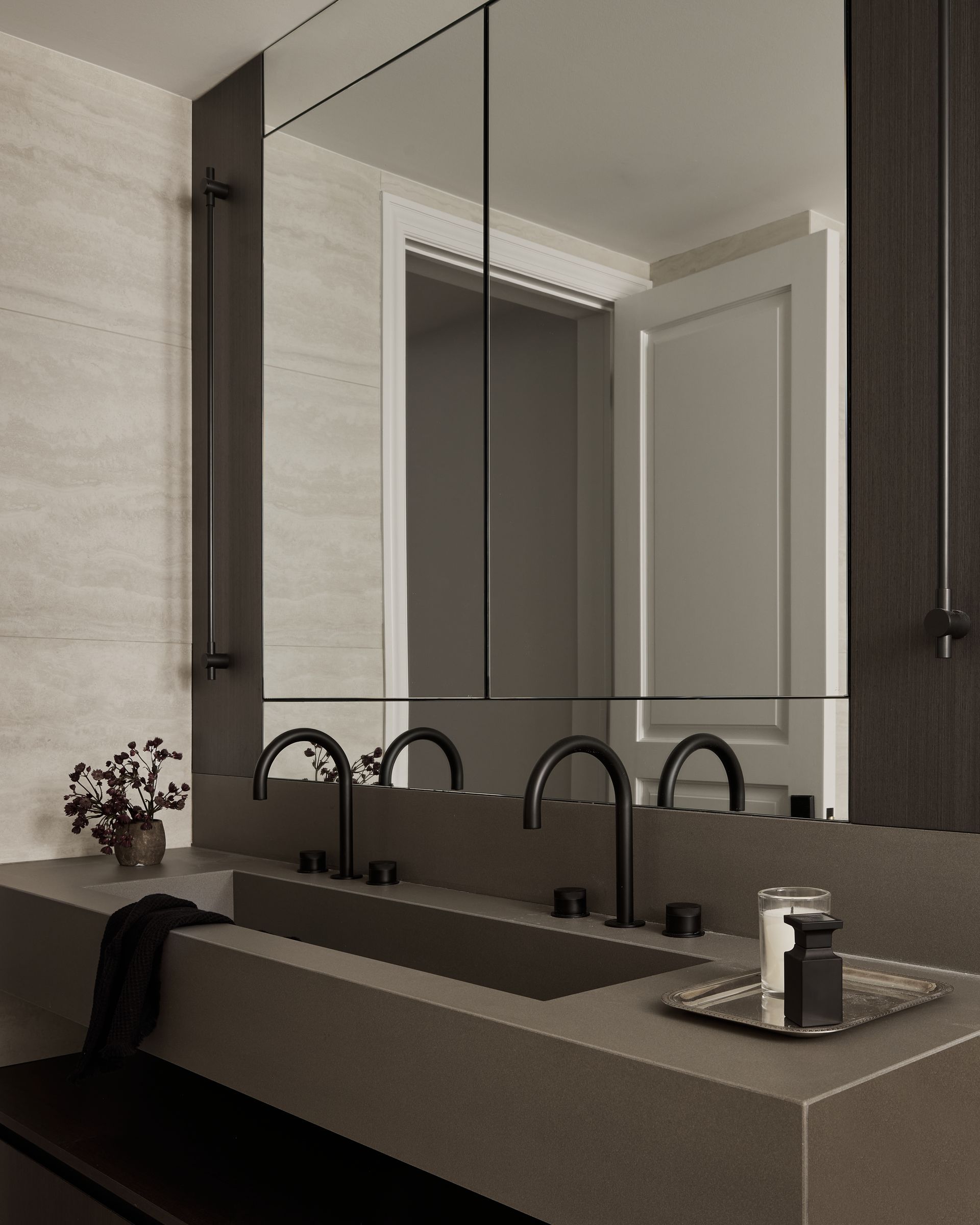 A bathroom with two sinks and a large mirror