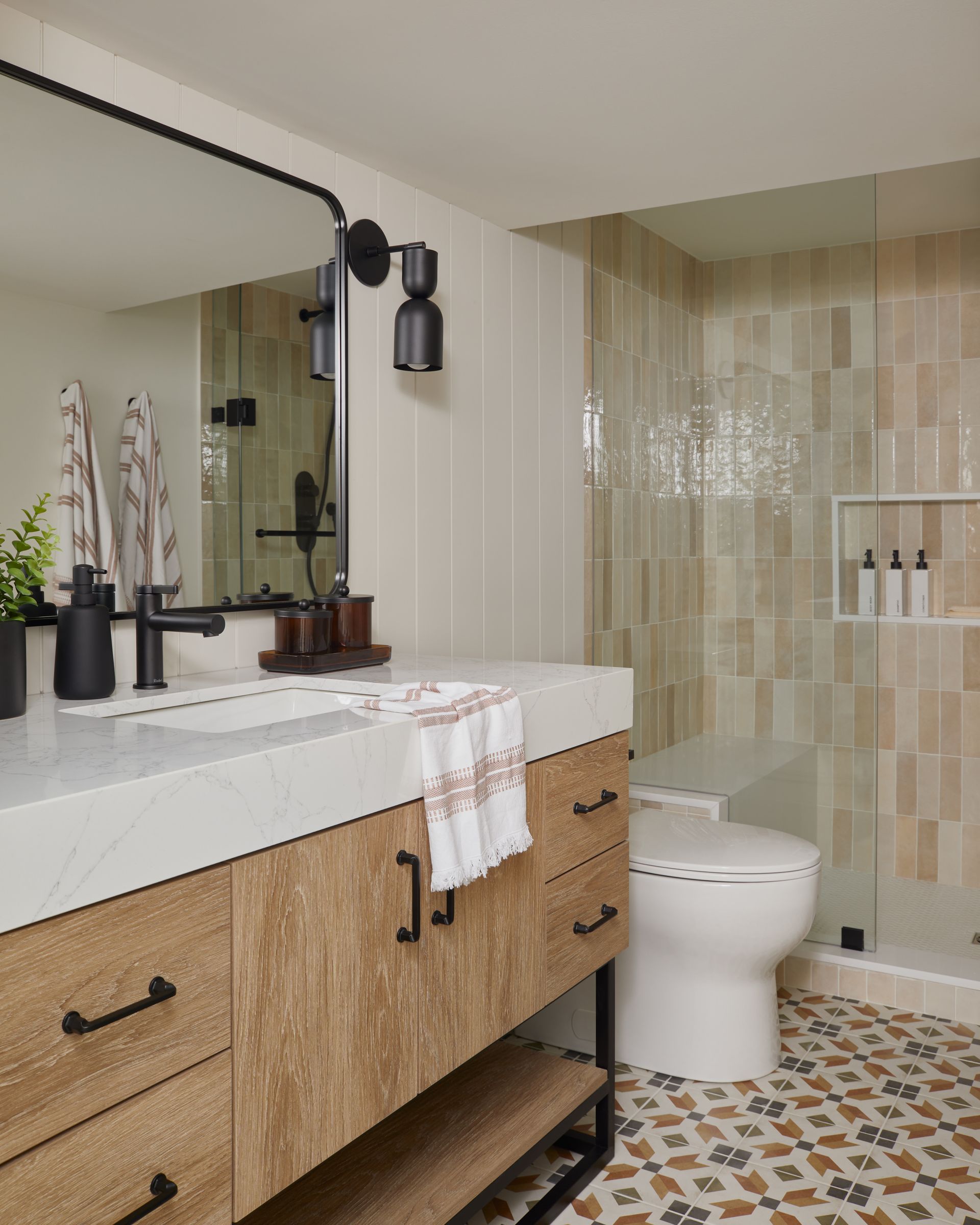 A bathroom with a sink , toilet , and mirror.