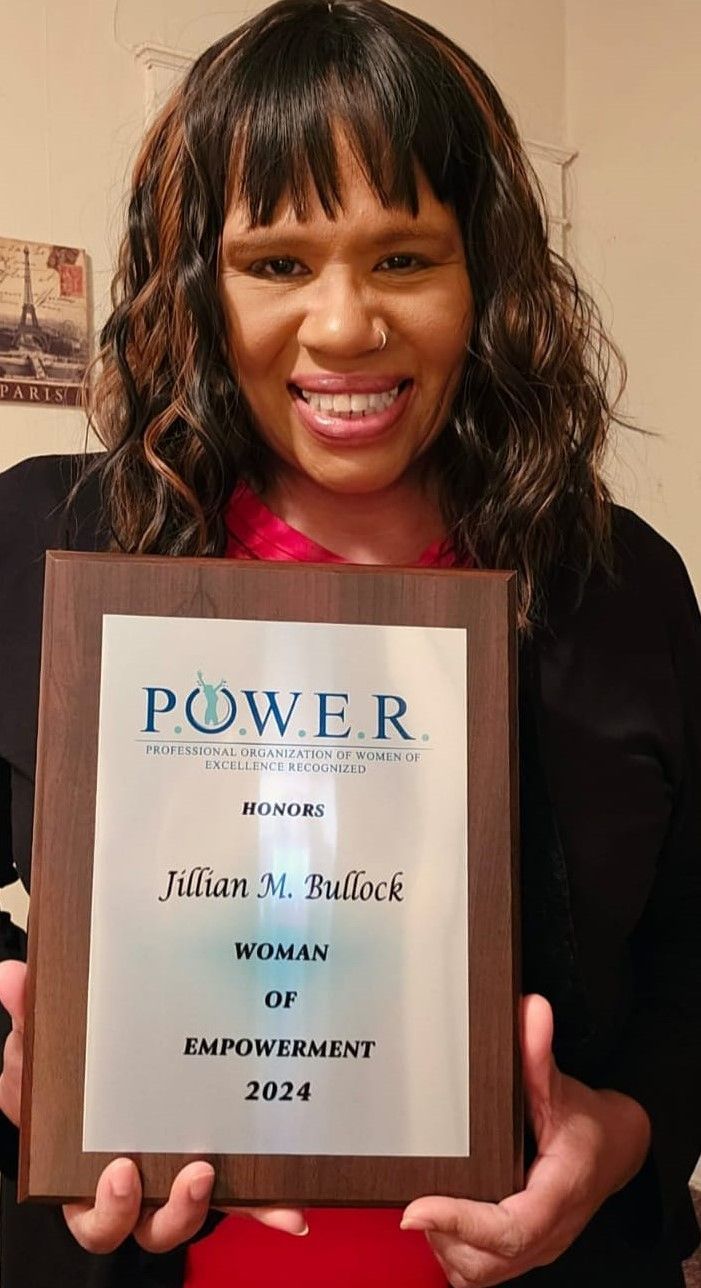 Jillian Bullock holding her P.O.W.E.R. Honors award plaque