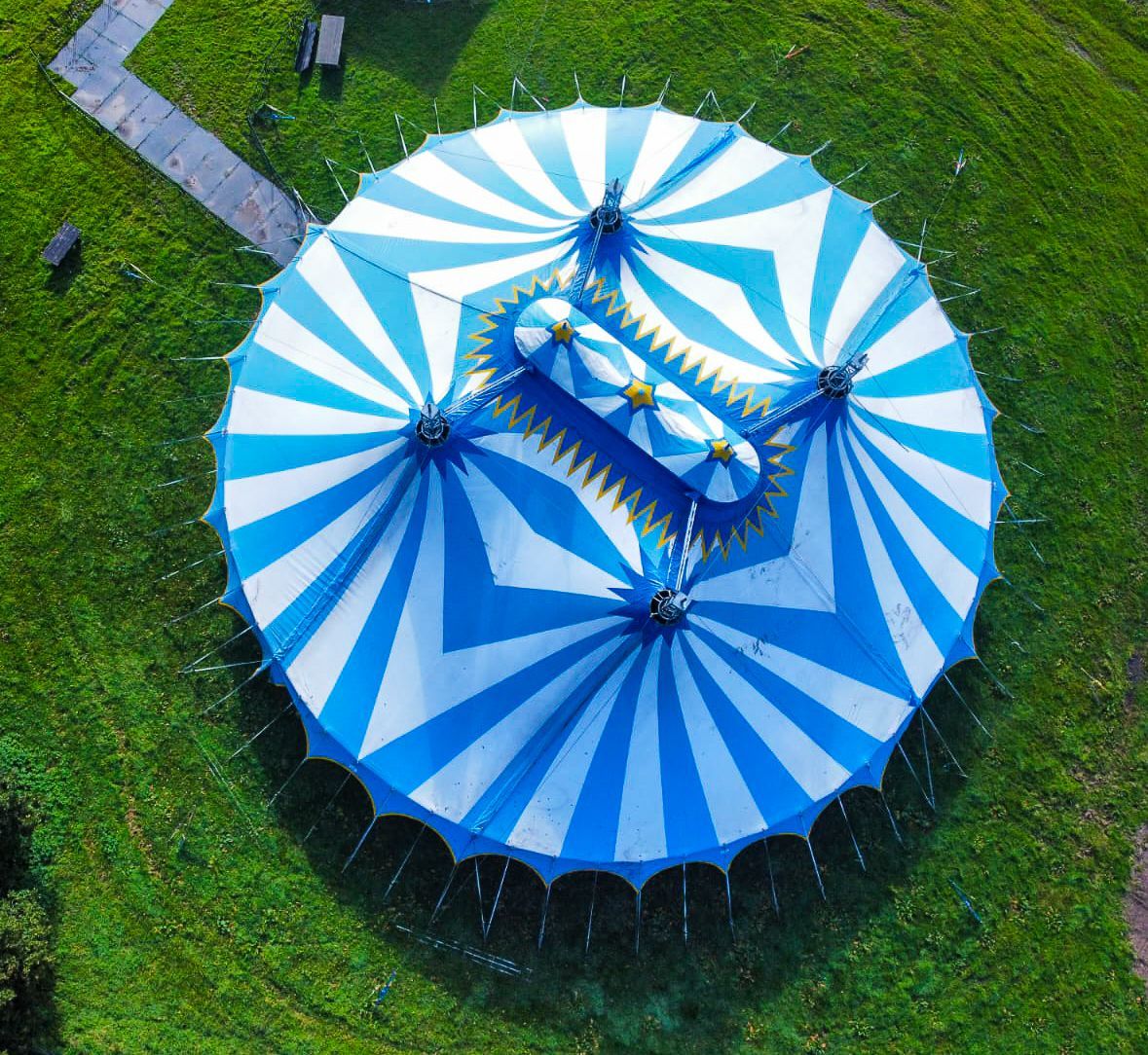 An aerial view of a blue and white circus tent