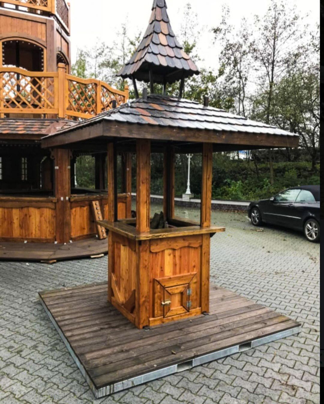 A wooden structure with a roof that looks like a pagoda
