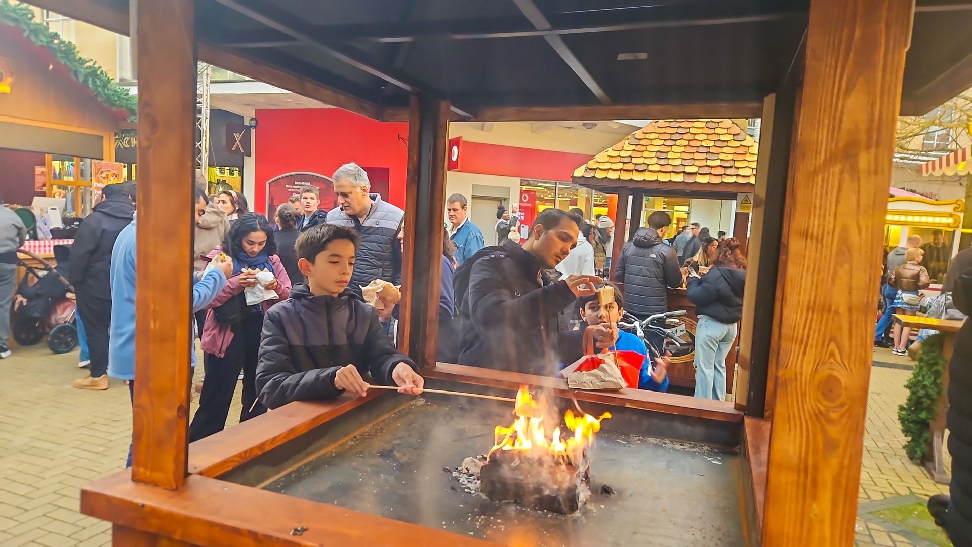 A group of people are gathered around a fire pit
