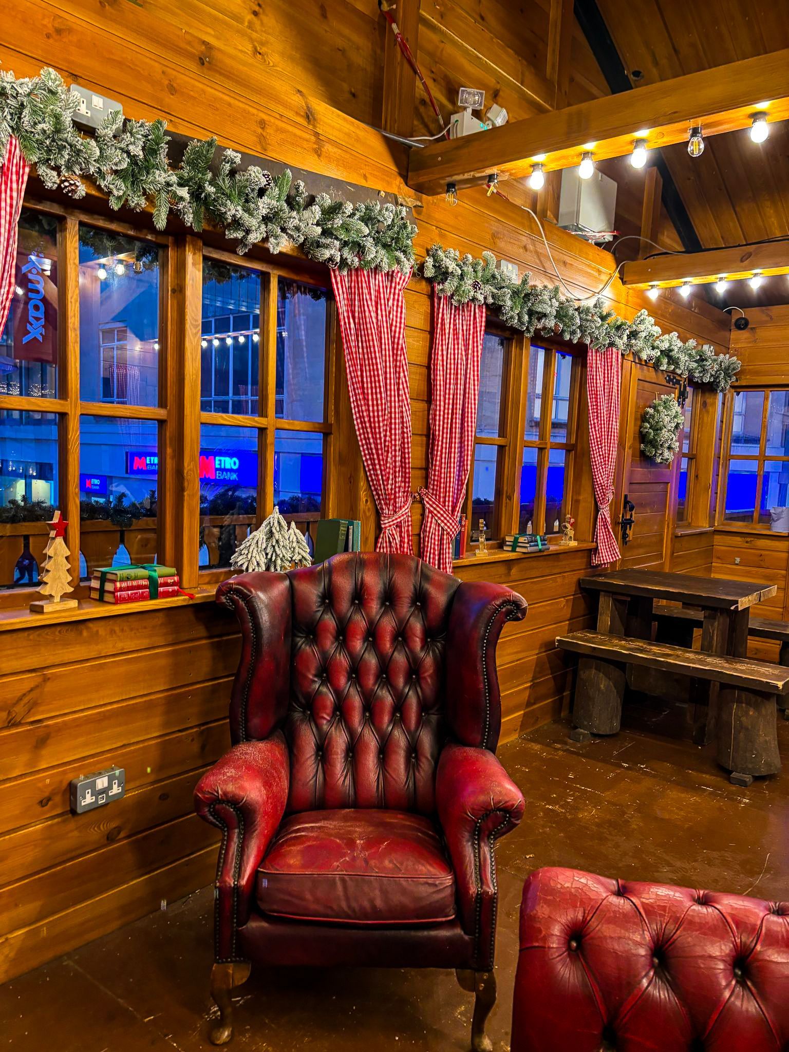 A red leather chair in a room with christmas decorations
