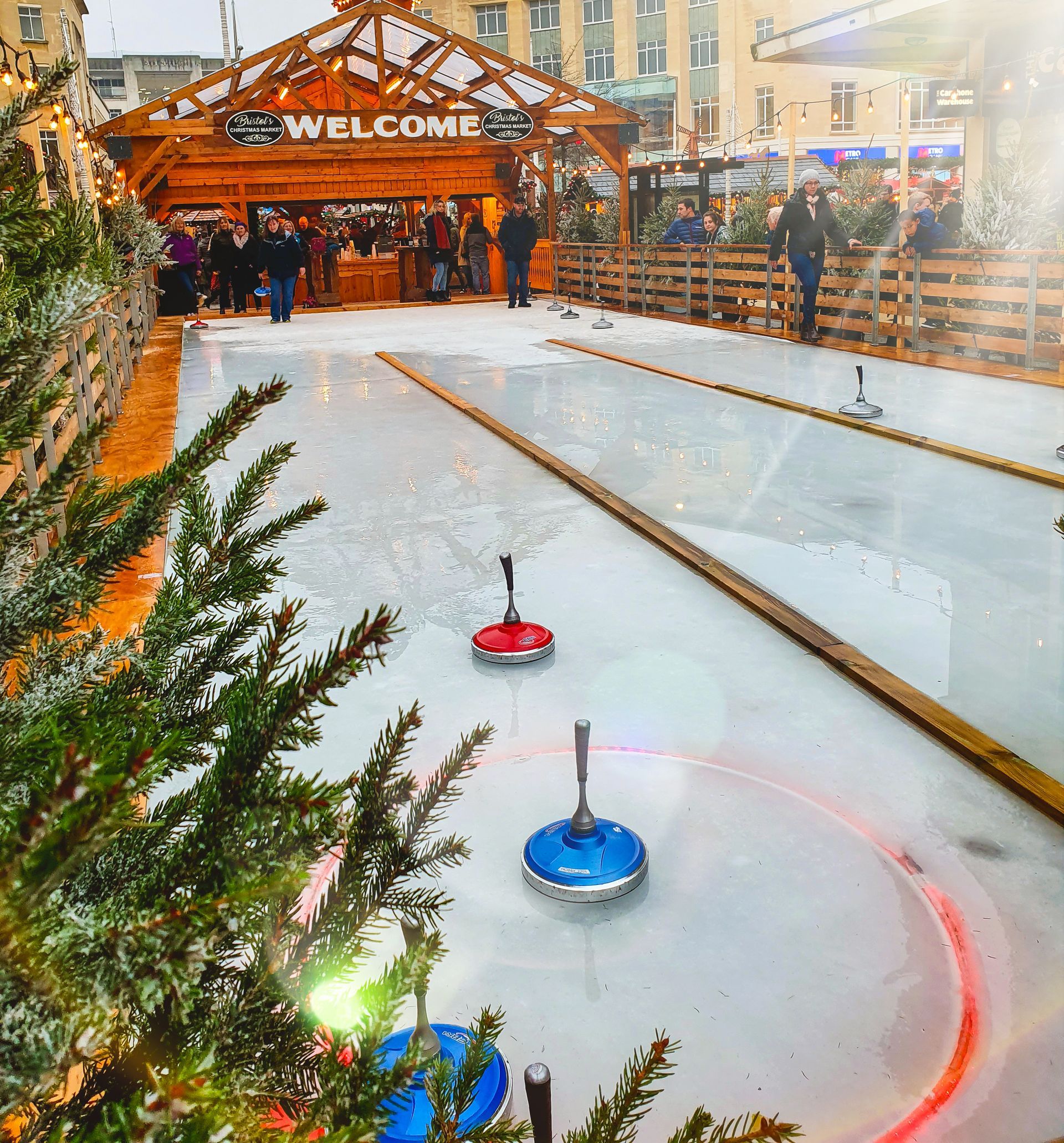 An ice rink with a welcome sign in the background
