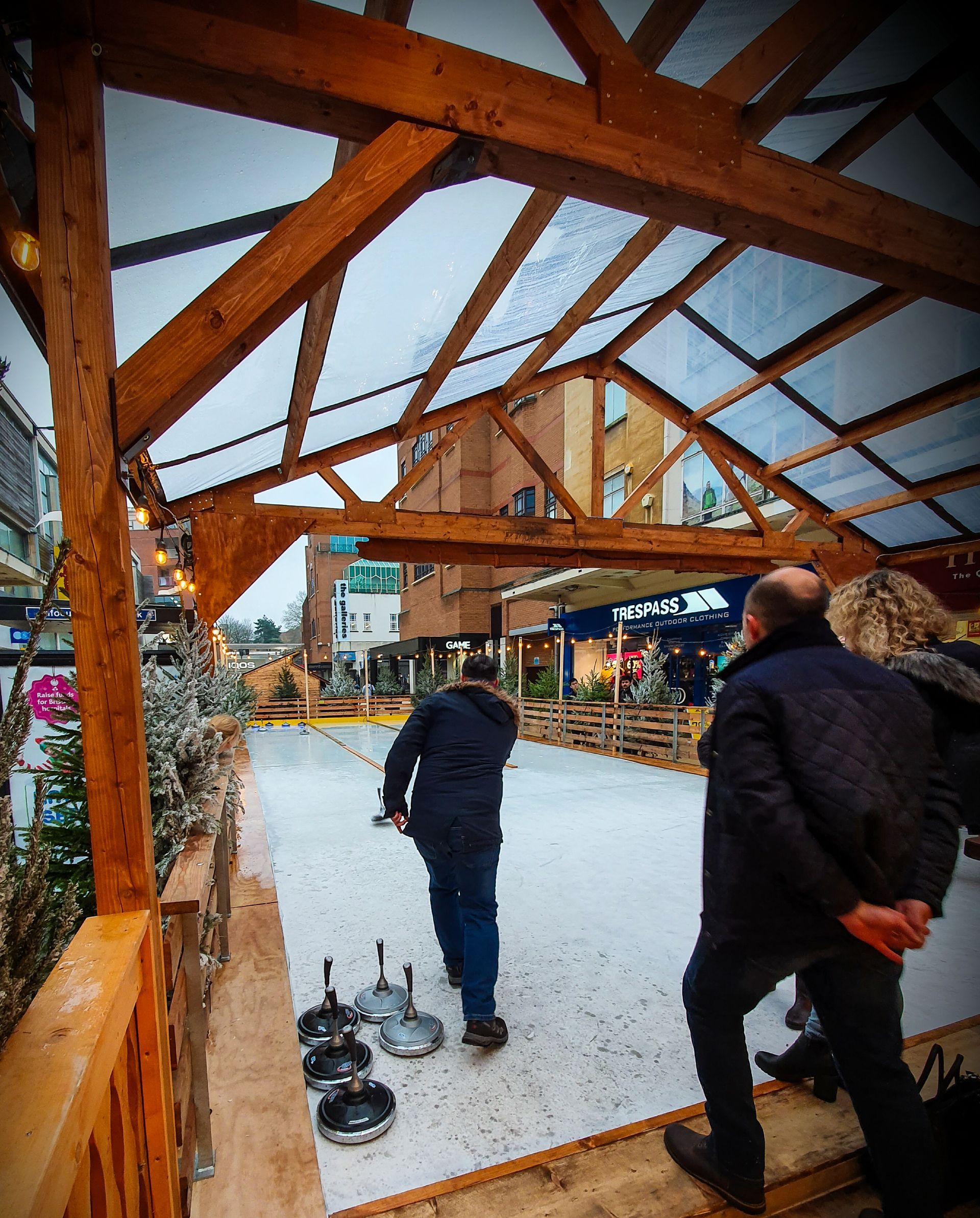 A group of people are playing a game of curling on ice.