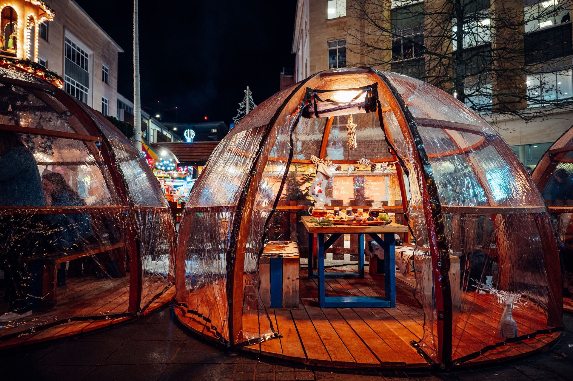 A dome with a table inside of it is lit up at night