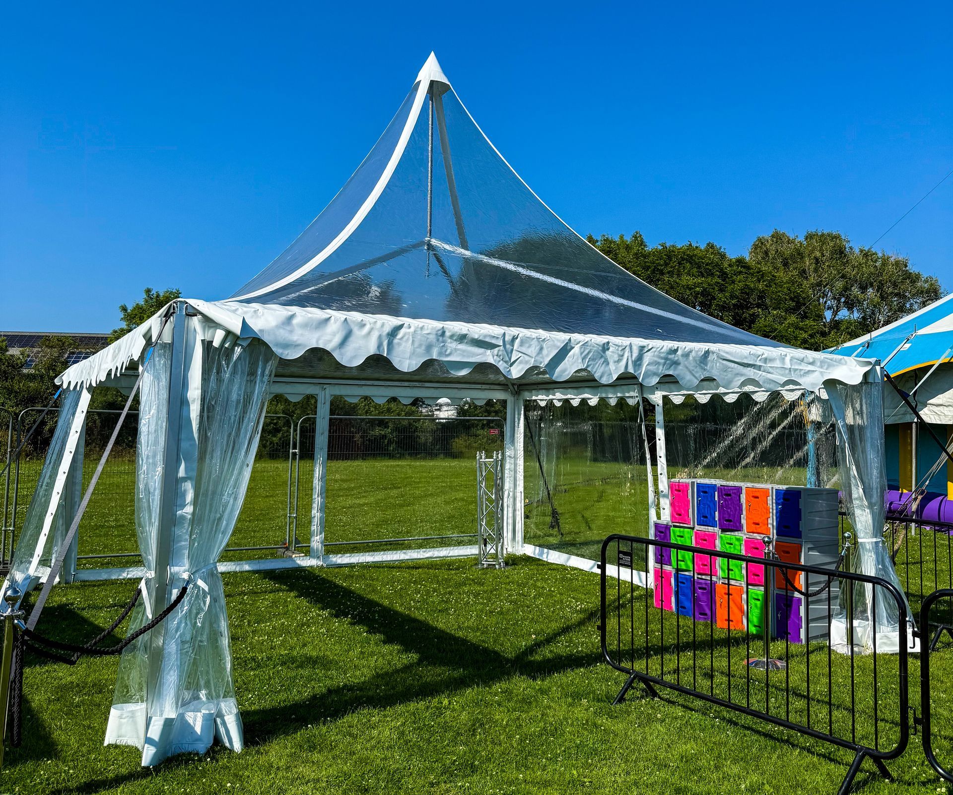 A clear tent is in the middle of field