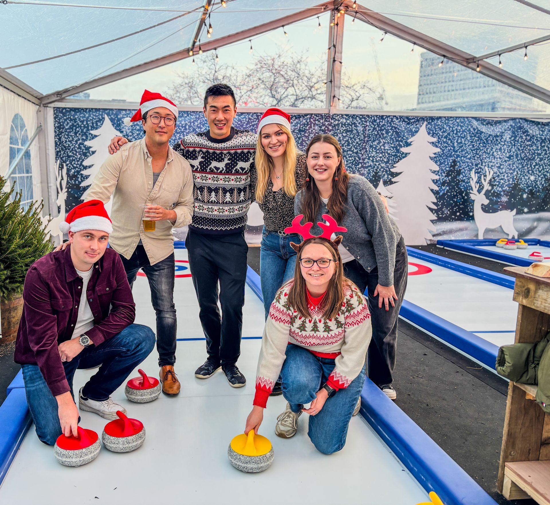 A group of people wearing santa hats are posing for a picture