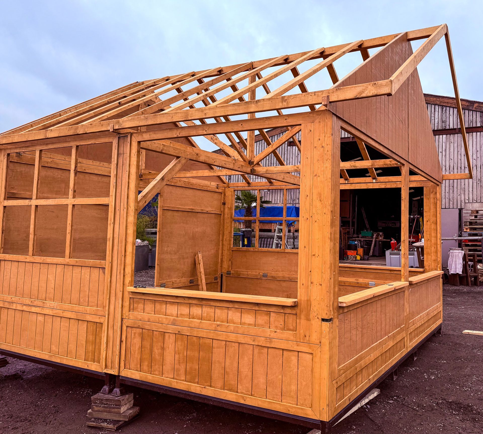 A wooden structure with a roof is being built