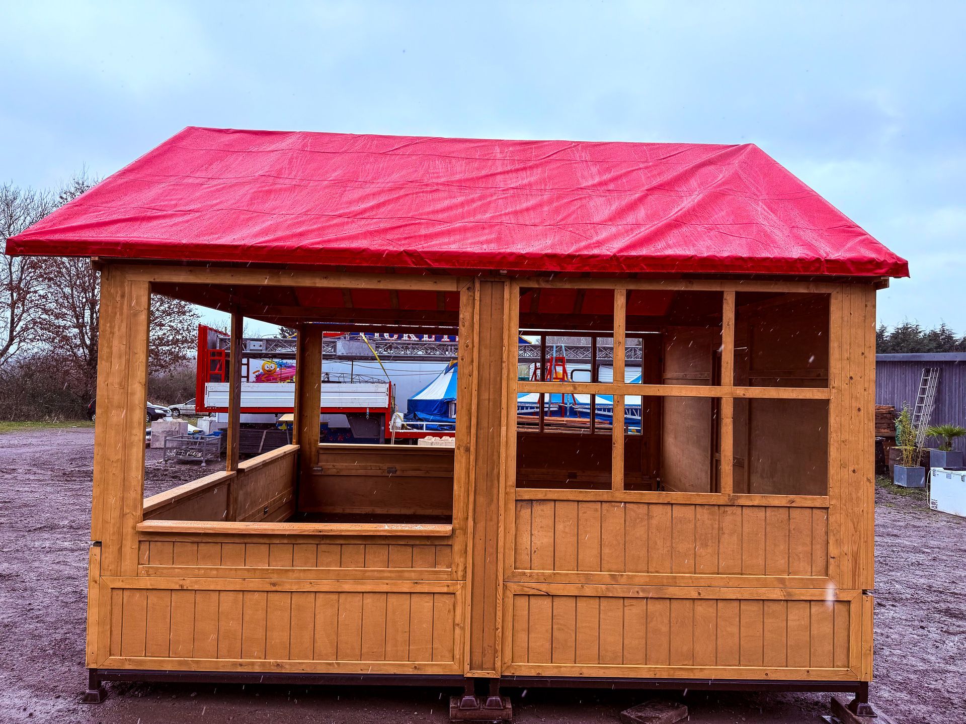 A small wooden house with a red roof