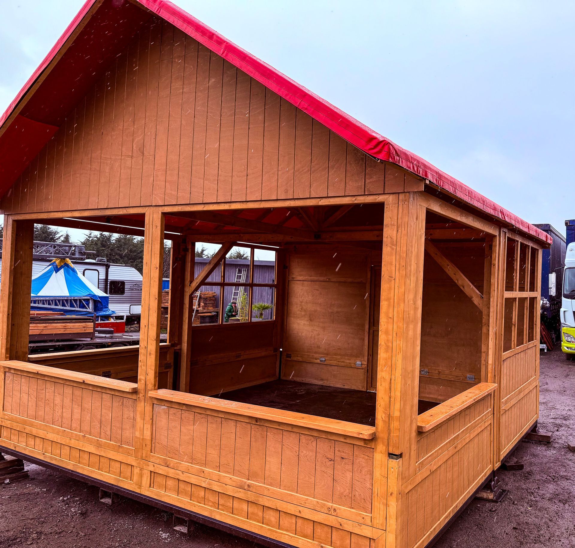 A small wooden house with a red roof