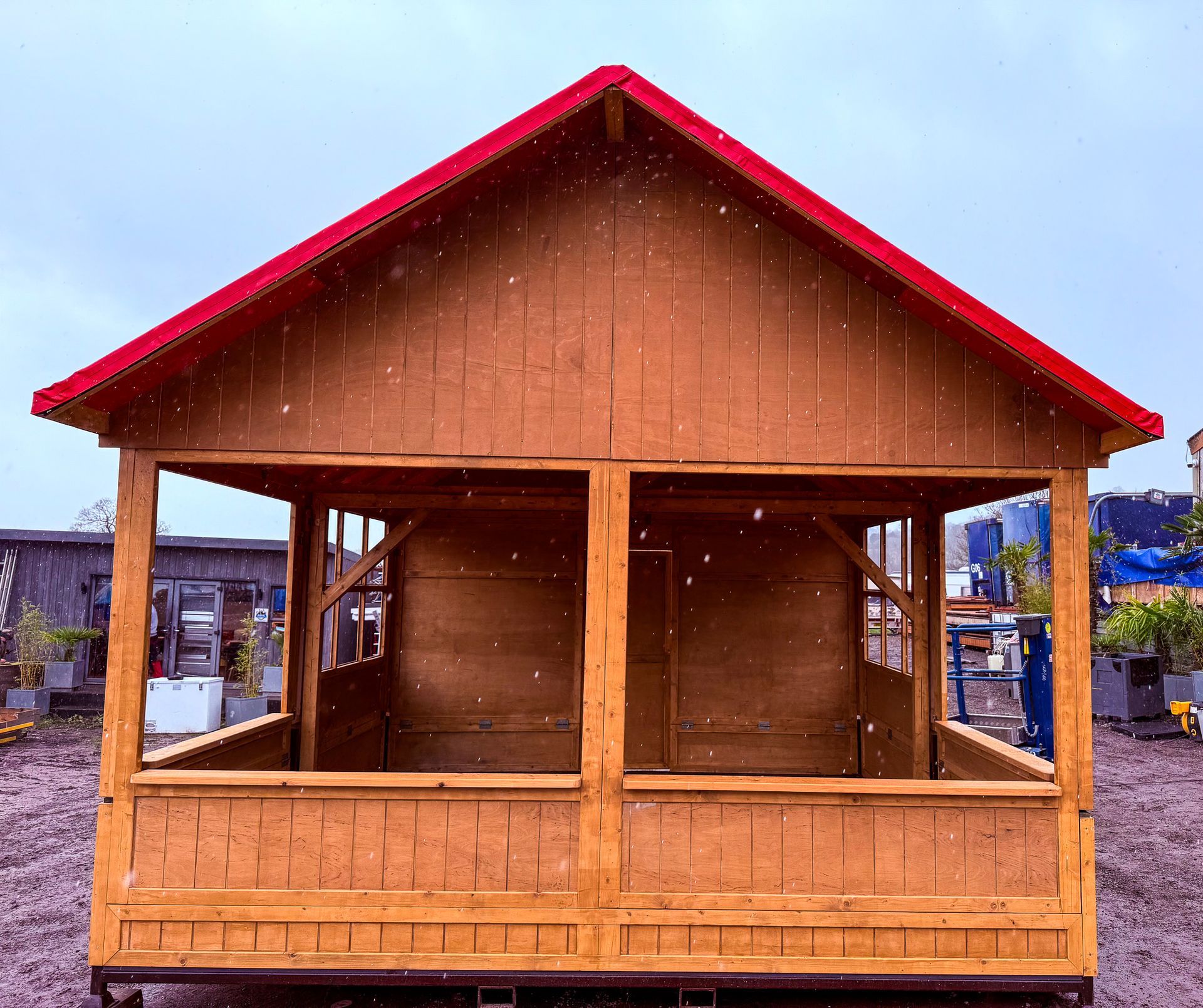 A small wooden house with a red roof