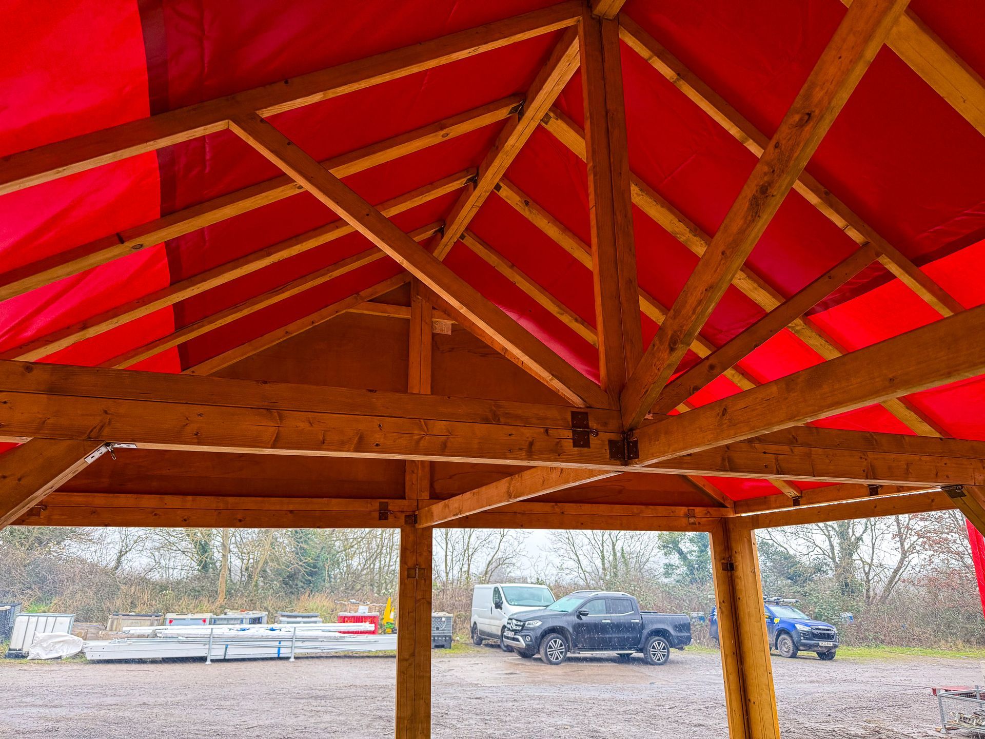 The inside of a wooden structure with a red roof