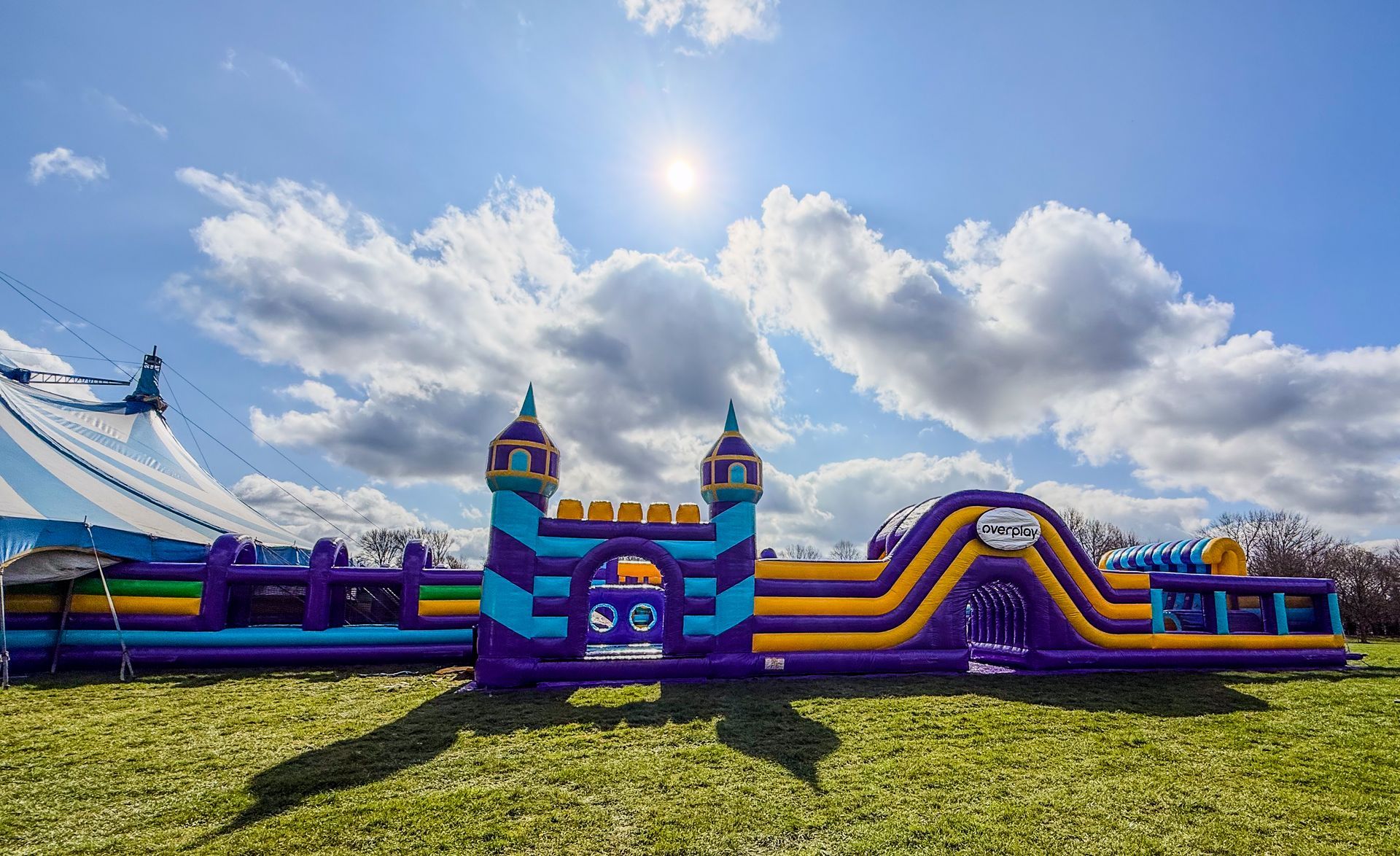 A large inflatable castle is in the middle of a grassy field