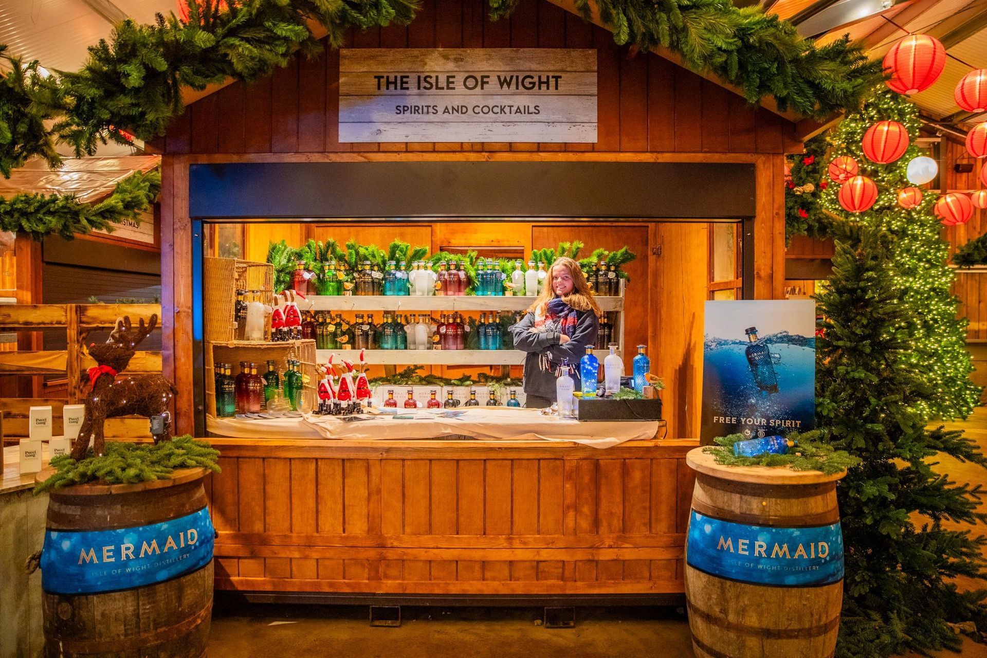 A wooden building with barrels that say mermaid on them