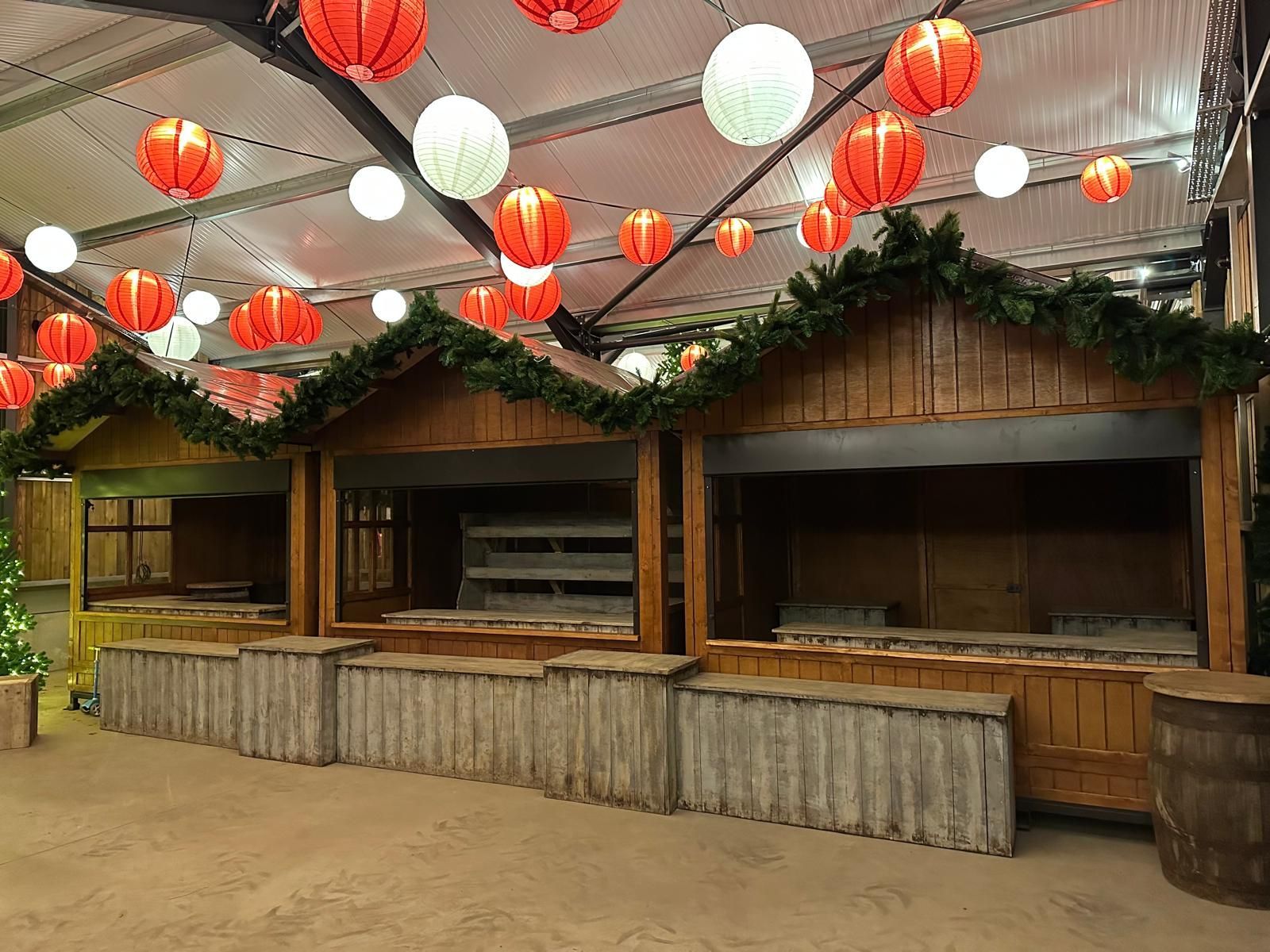 A wooden building with lanterns hanging from the ceiling