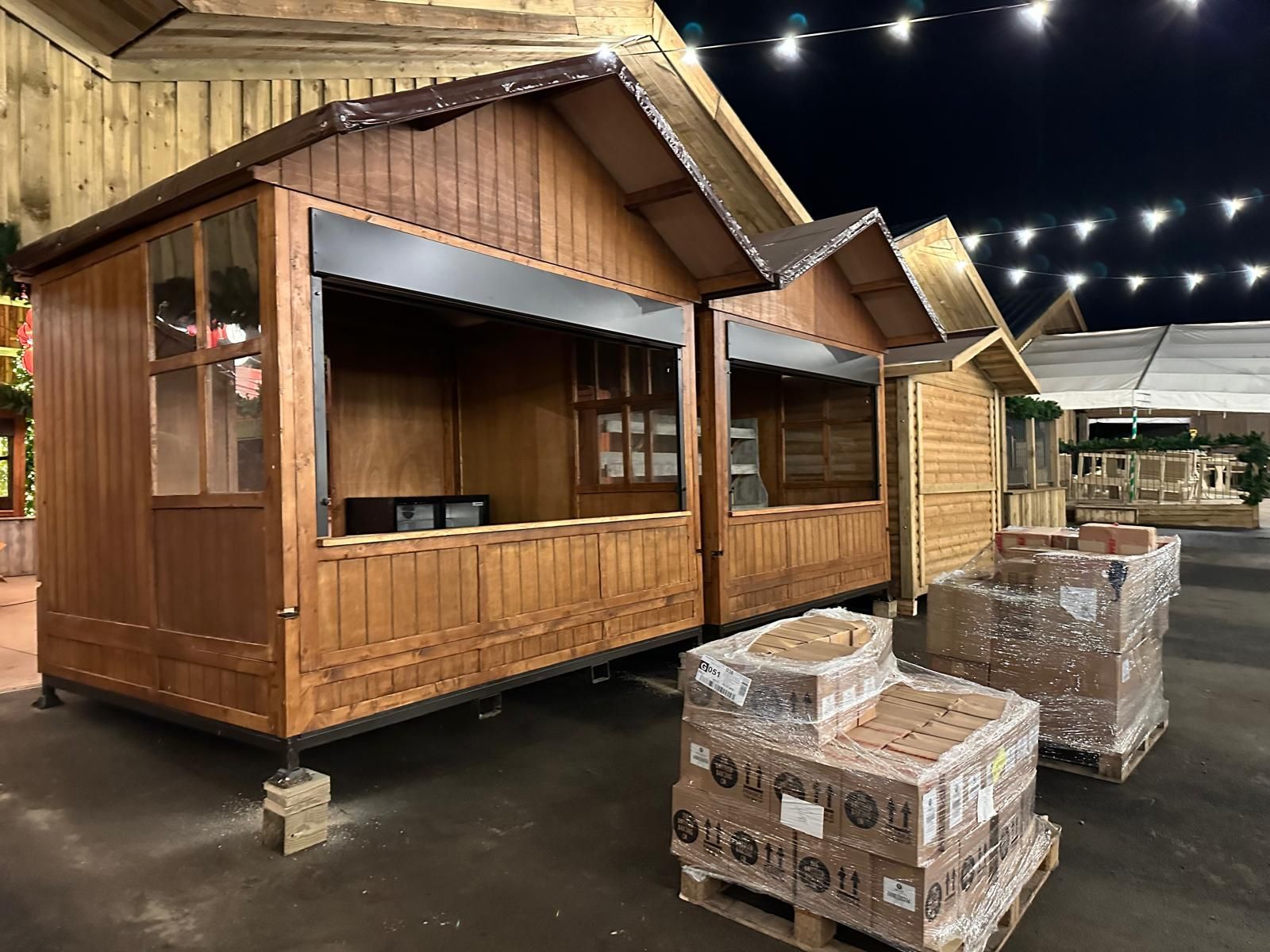 A row of wooden huts are lined up
