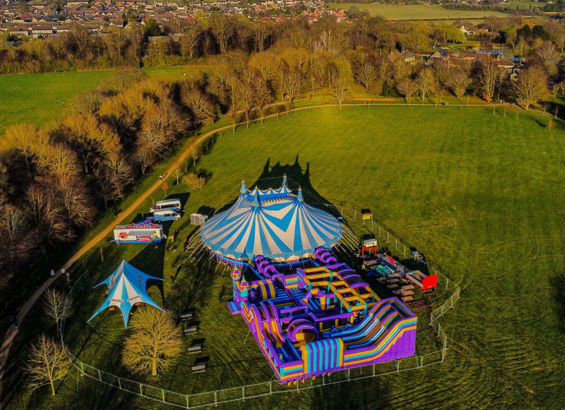 An aerial view of a the inflatable bounce park in a field