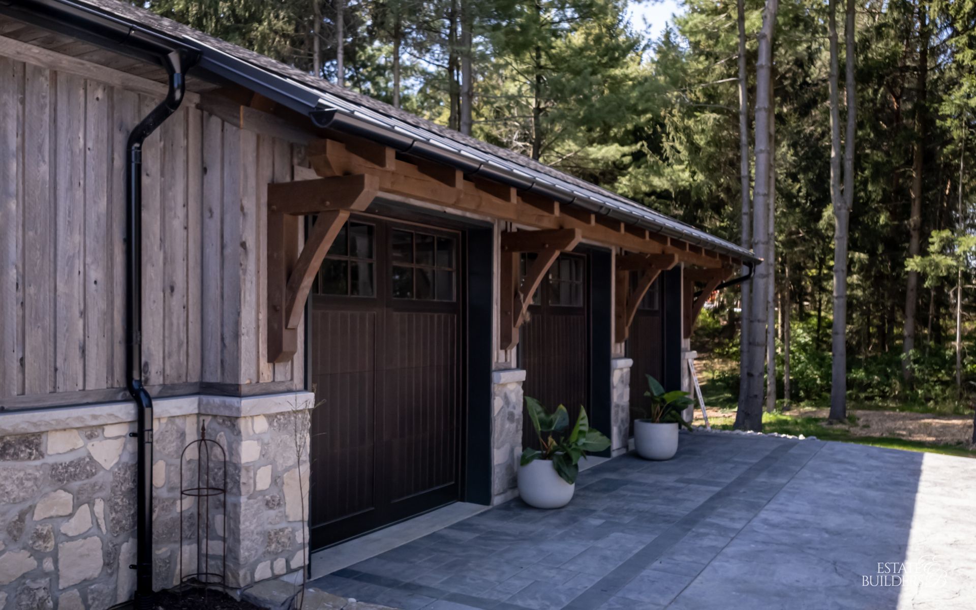 A row of garage doors sitting next to each other in front of a house.