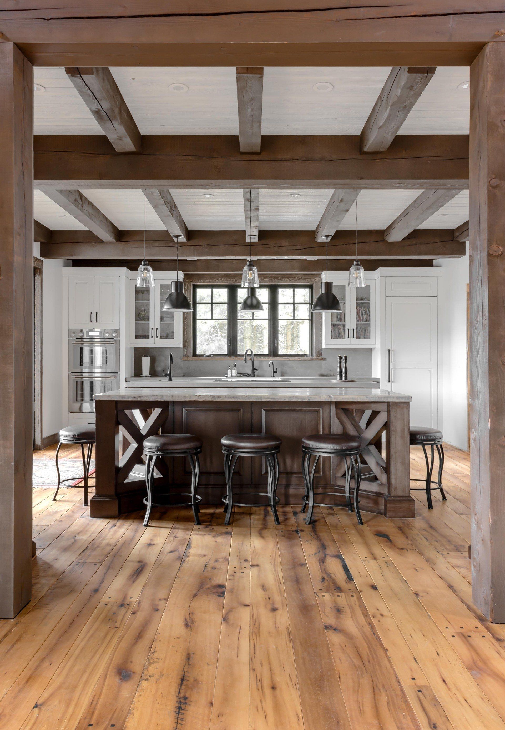 A kitchen with a large island and wooden timber frame.