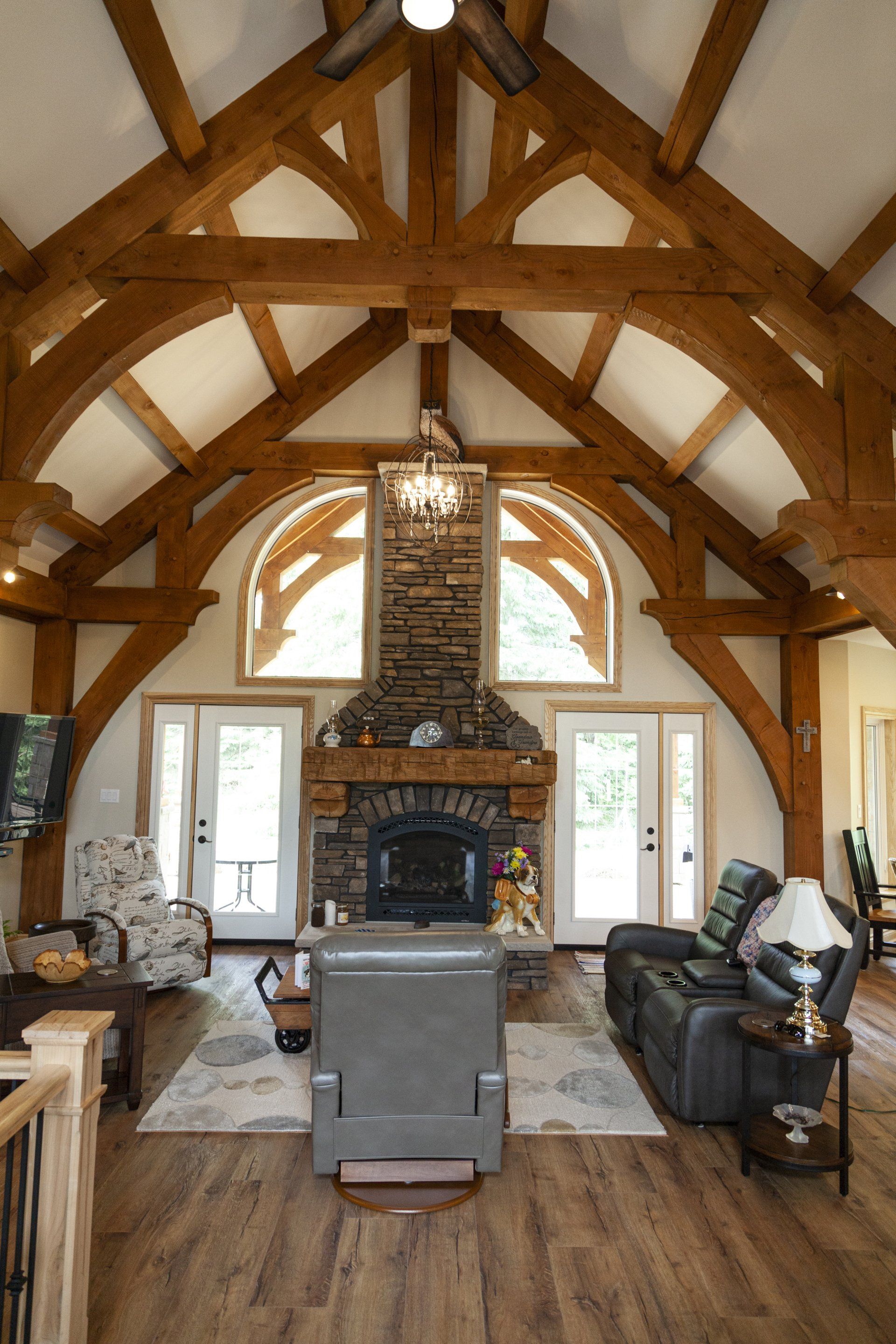 A living room with a fireplace and wooden timber beams.
