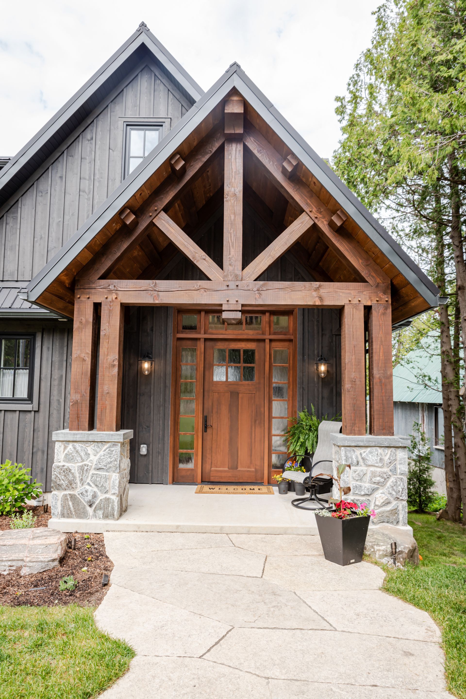 The front of a house with a wooden timber frameporch and a wooden door.