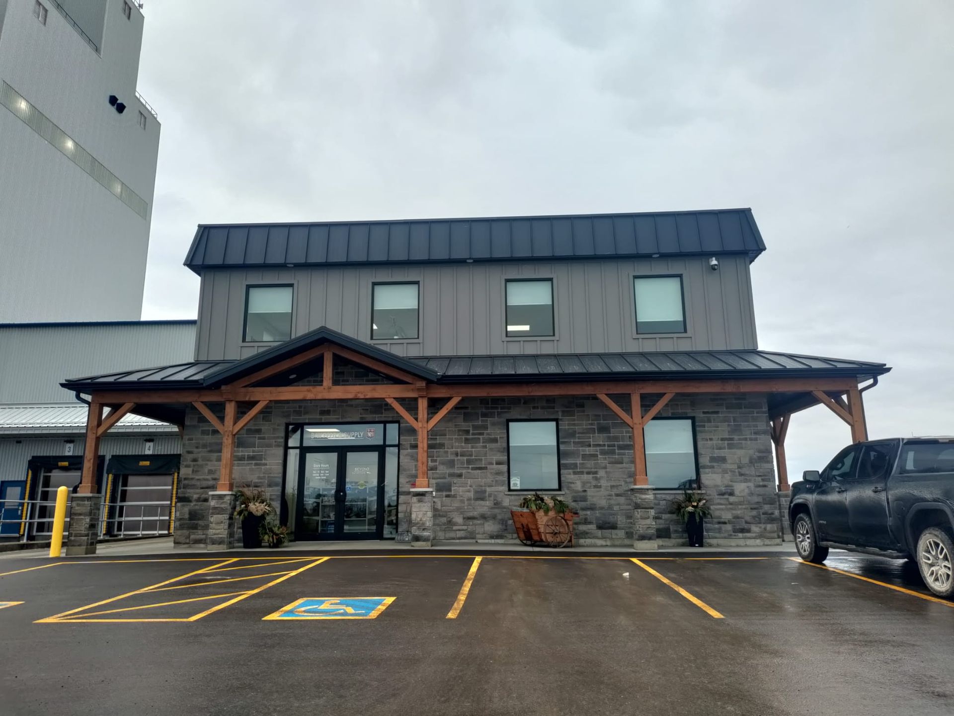 A large building with a handicapped parking spot in front of it.
