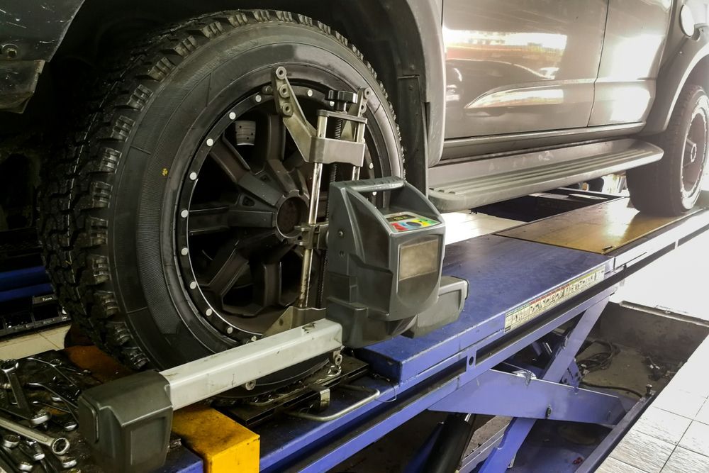 Car Tire on a Lift Being Aligned — COOTA Automotive Services in Ballarat East, VIC