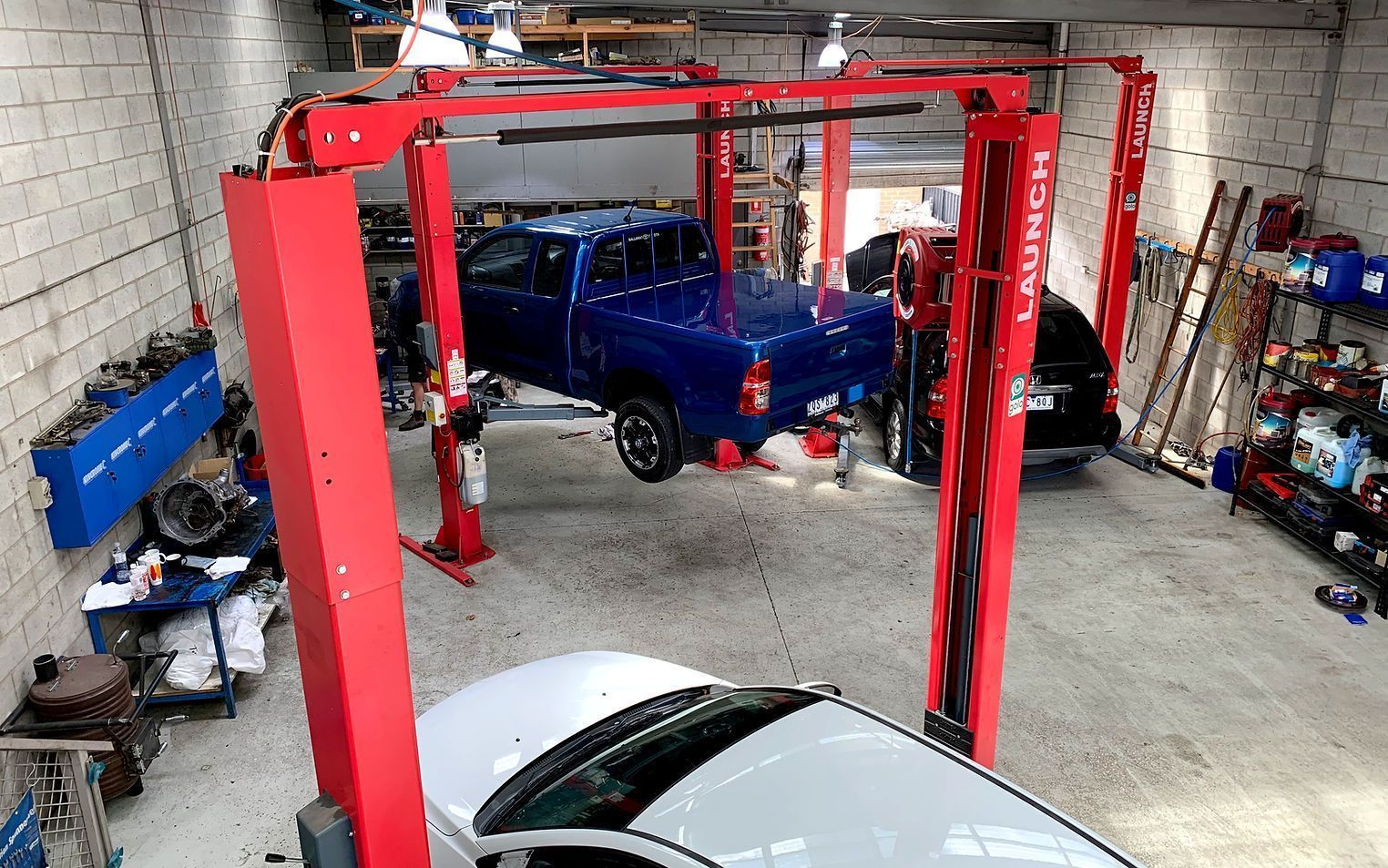 Blue Pickup Truck Elevated on a Red Automotive — COOTA Automotive Services in Ballarat East, VIC