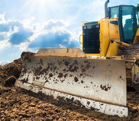 yellow dozer moving dirt on worksite in sunshine coast