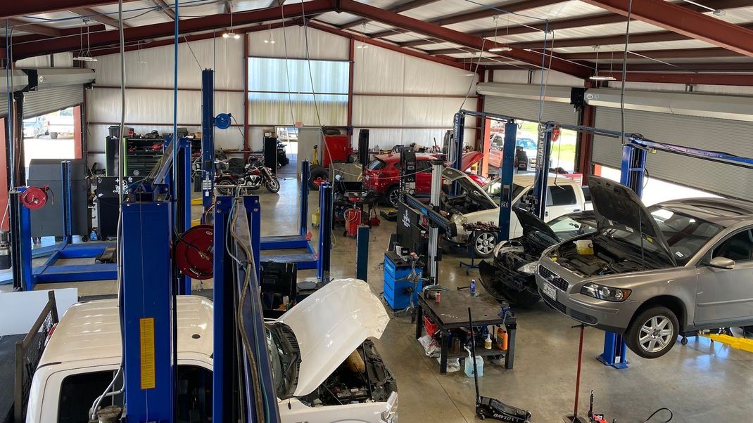 Auto Repair Shop Interior With Multiple Vehicles On Lifts and Open Bays | San Marcos Auto Center