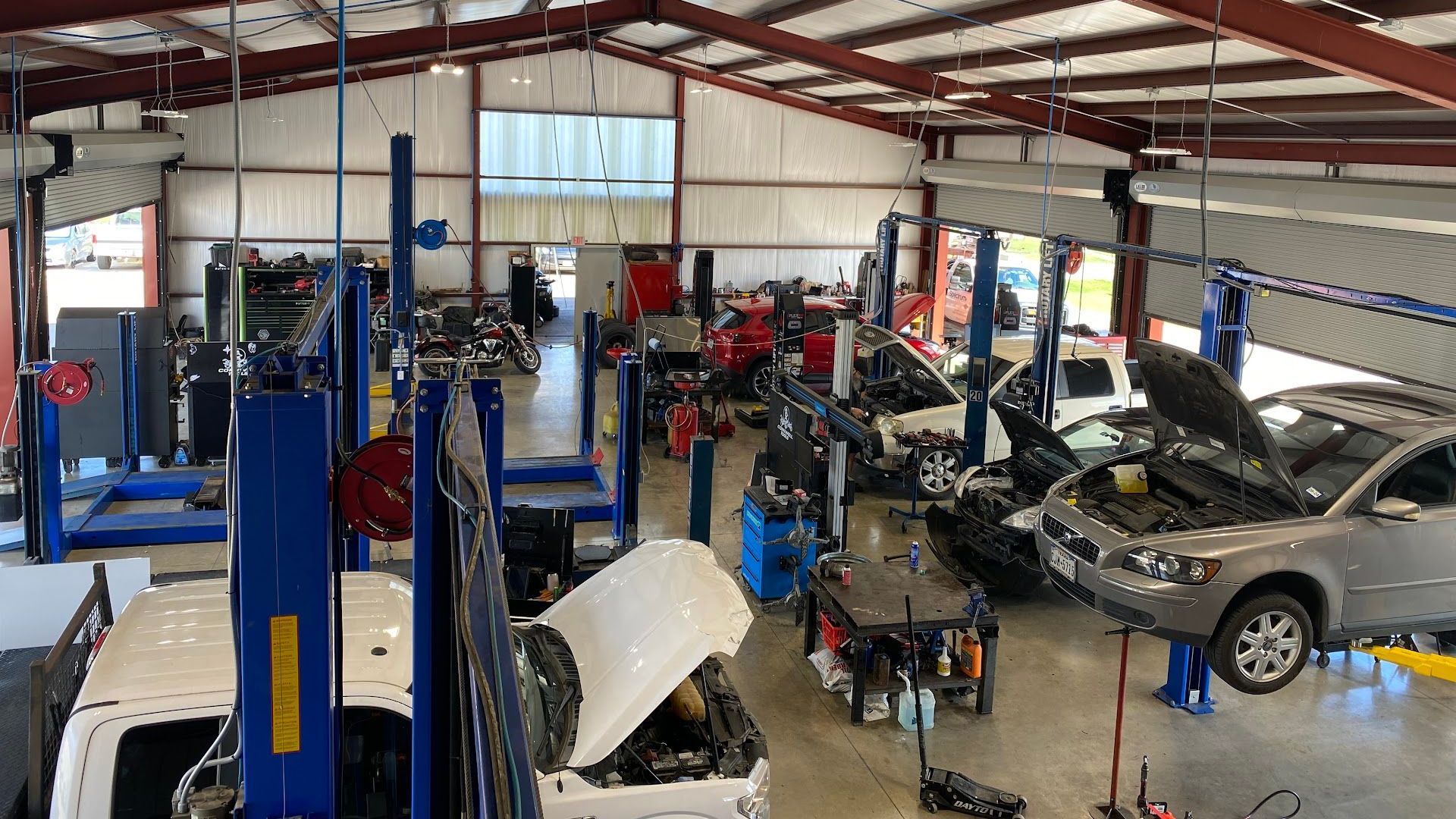 Auto Repair Shop Interior With Multiple Vehicles On Lifts and Open Bays | San Marcos Auto Center