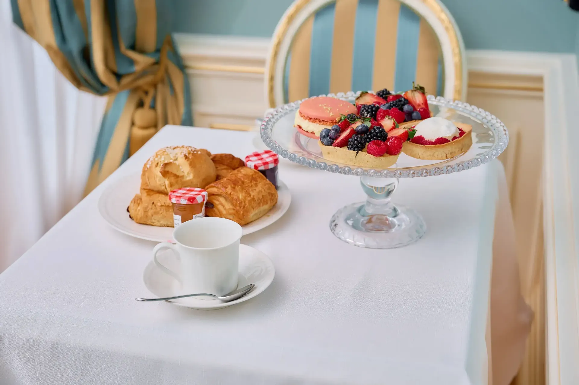A table topped with plates of food and a cup of coffee.