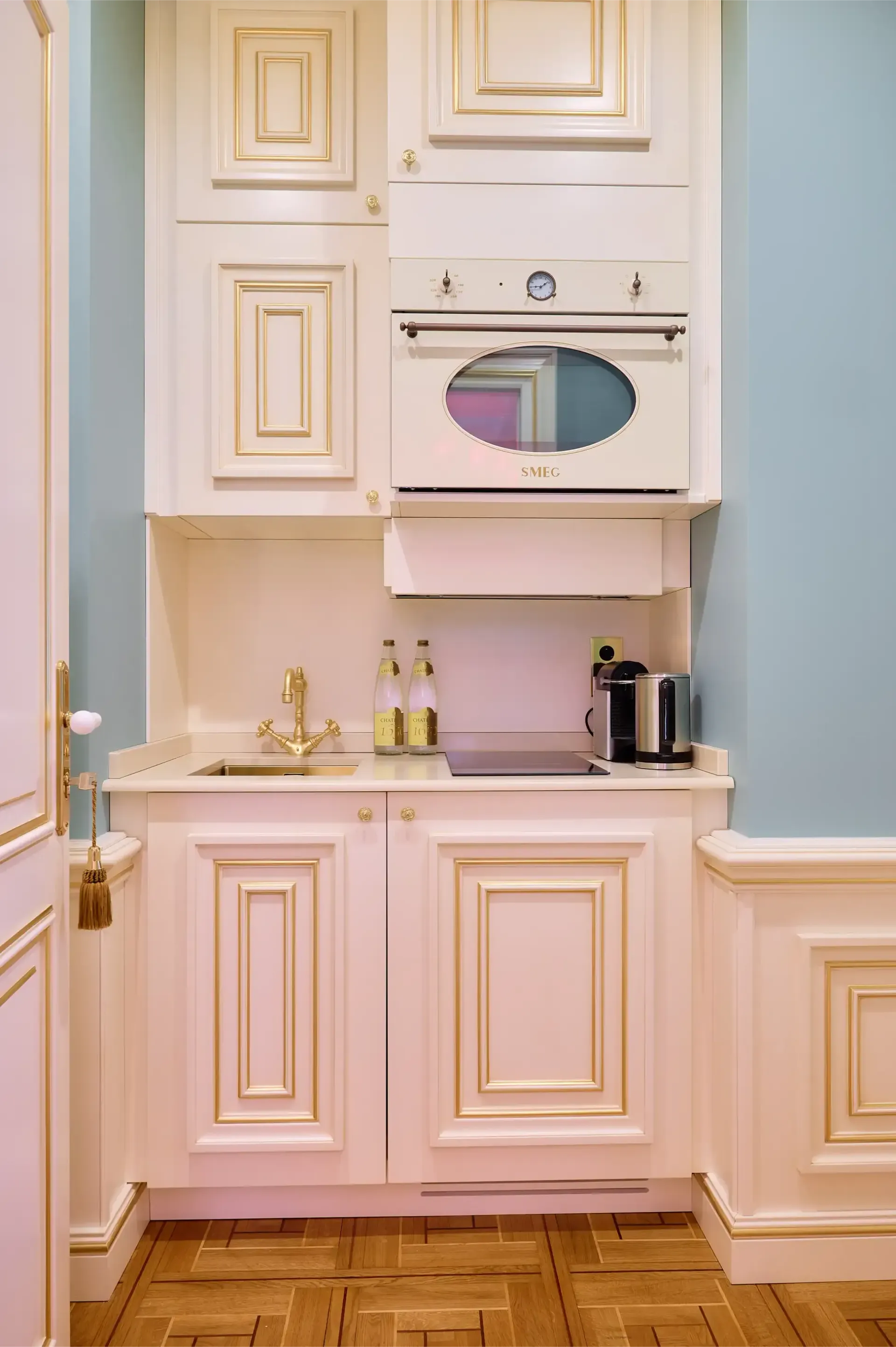 A small kitchen with white cabinets and a stove top oven