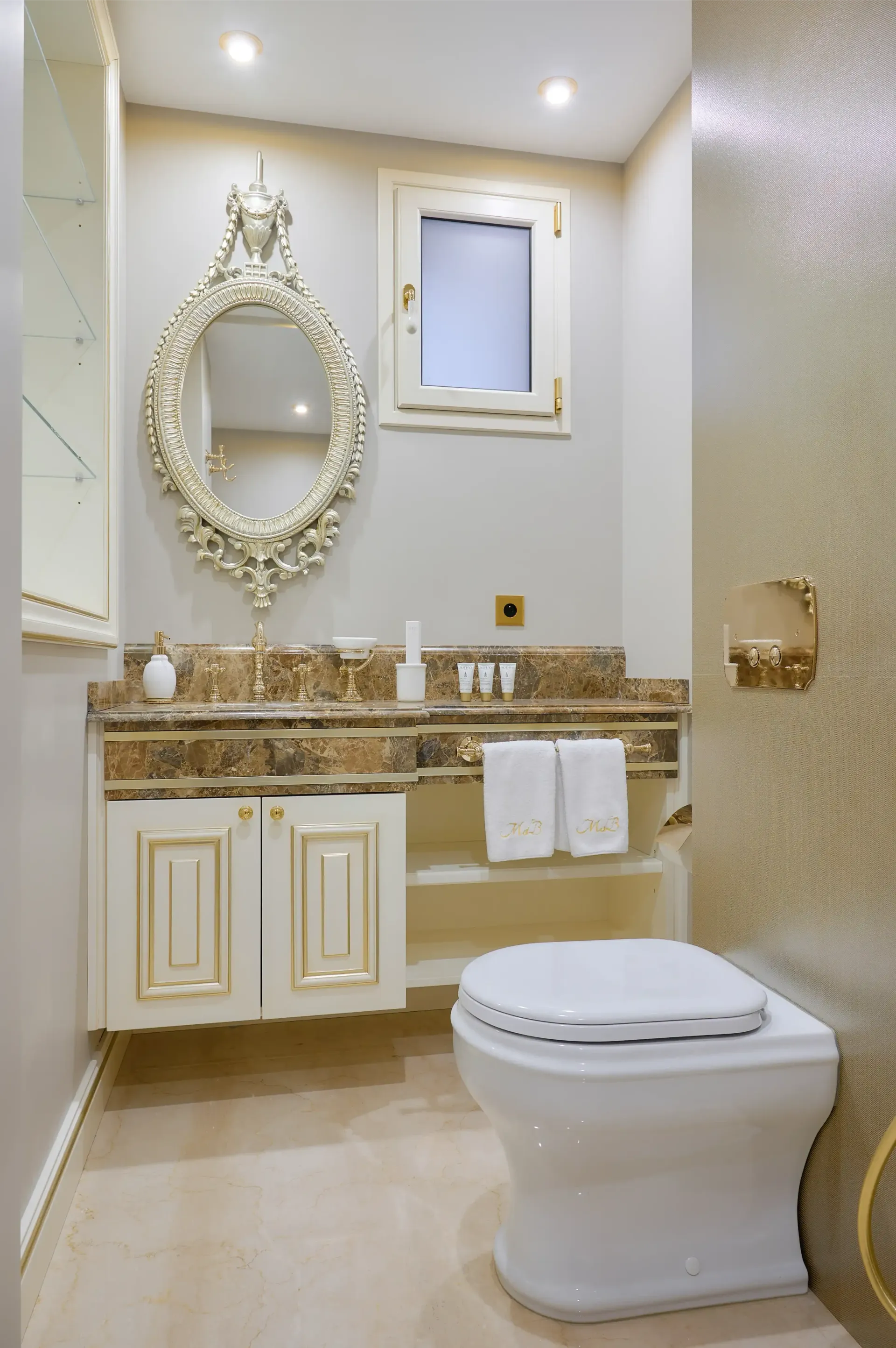 A bathroom with a toilet , sink and mirror.