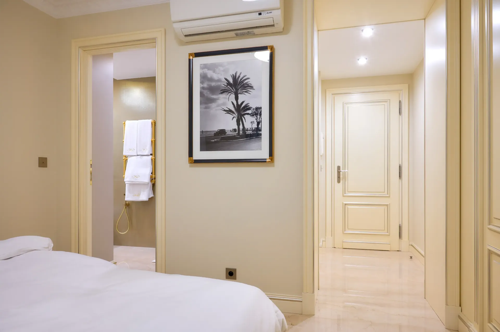 A bedroom with a bed and a picture on the wall