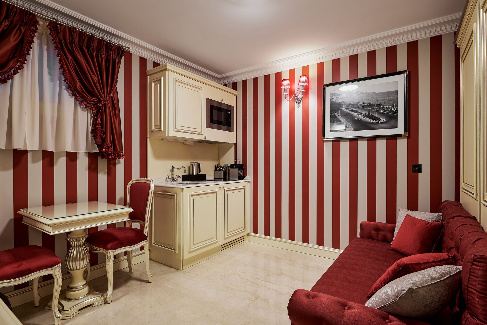 A bedroom with red and white striped walls and a bed.