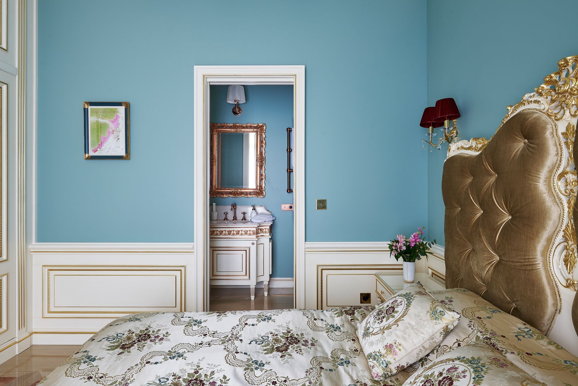 A bedroom with a bed , nightstand , and lamps.