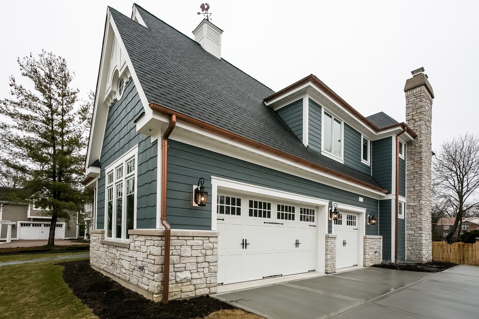 A large house with a garage and a chimney