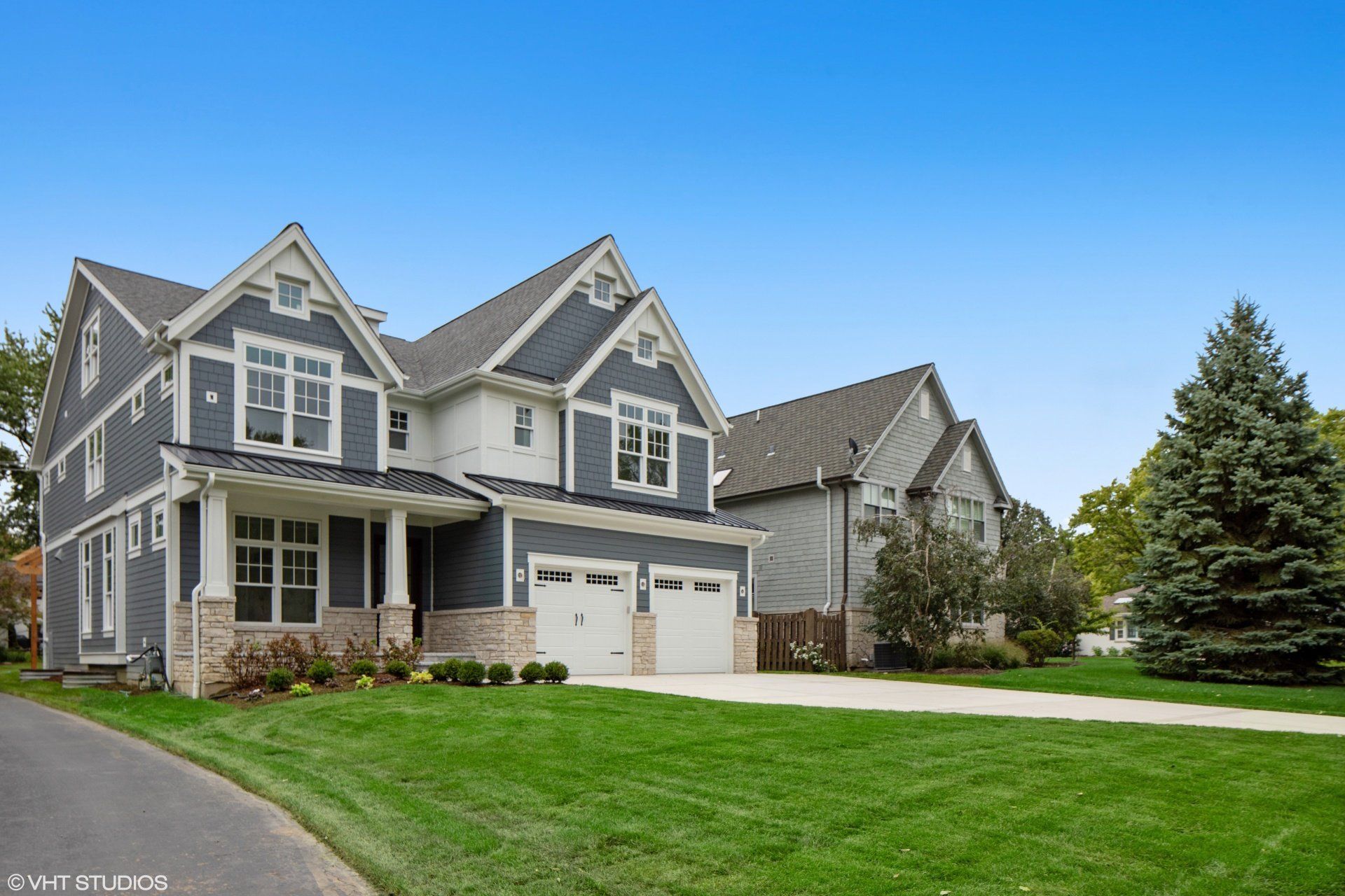 A large house with a lush green lawn in front of it.
