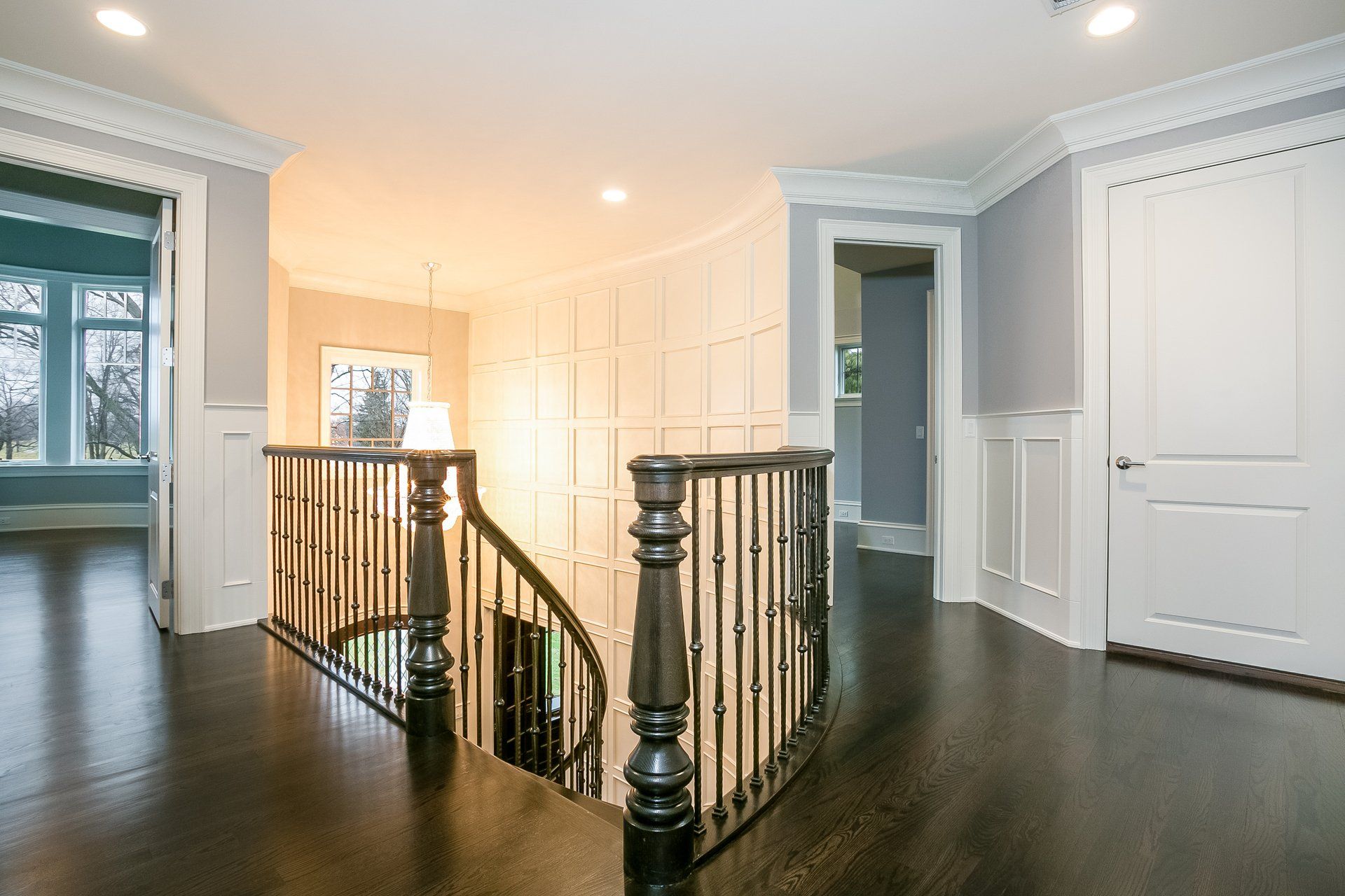 A staircase with a wrought iron railing in a house.