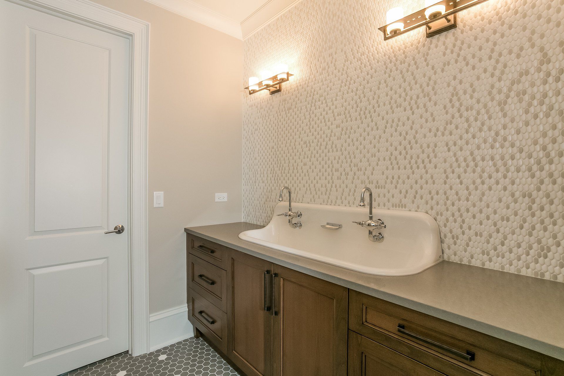 A bathroom with a double sink and wooden cabinets.