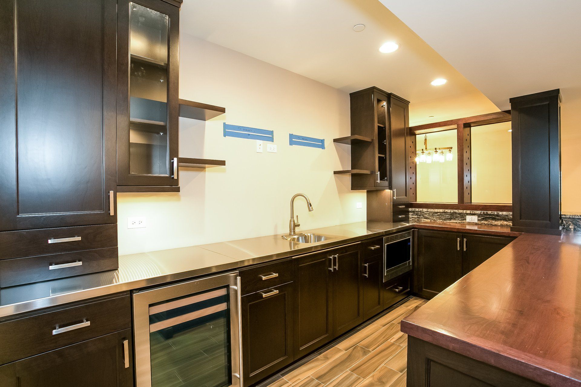 A kitchen with dark wood cabinets and stainless steel appliances