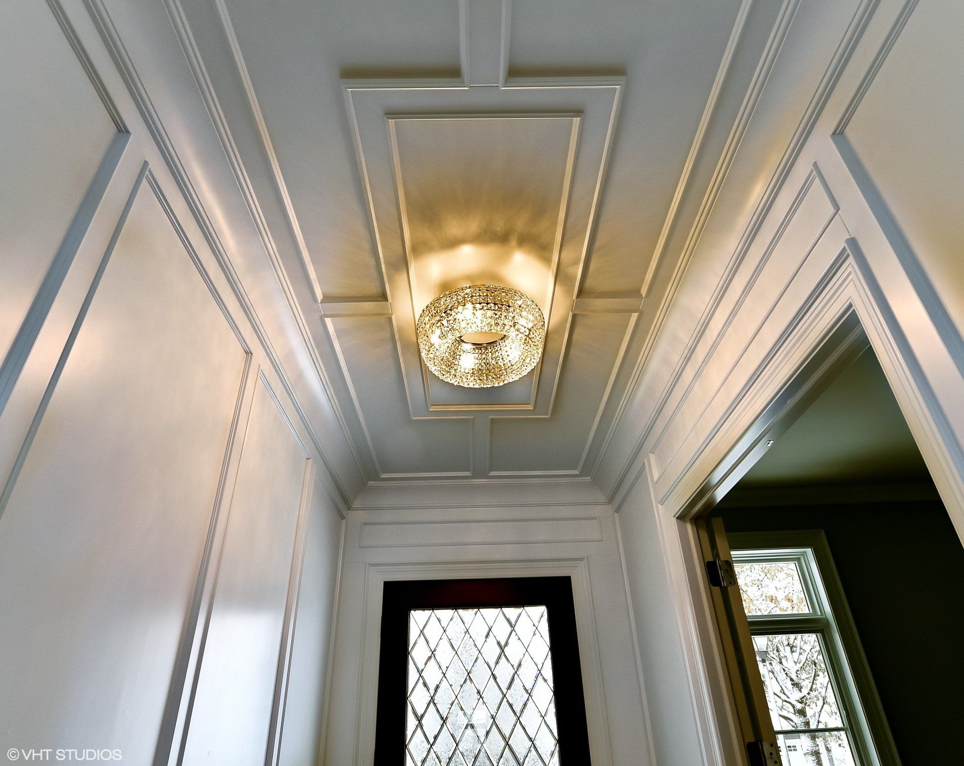 A hallway with a chandelier hanging from the ceiling