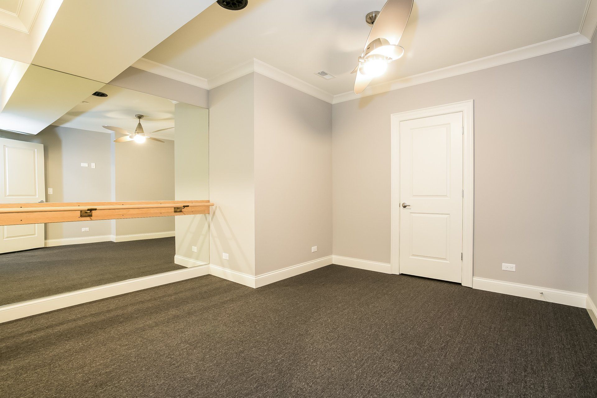 An empty room with a large mirror on the wall.