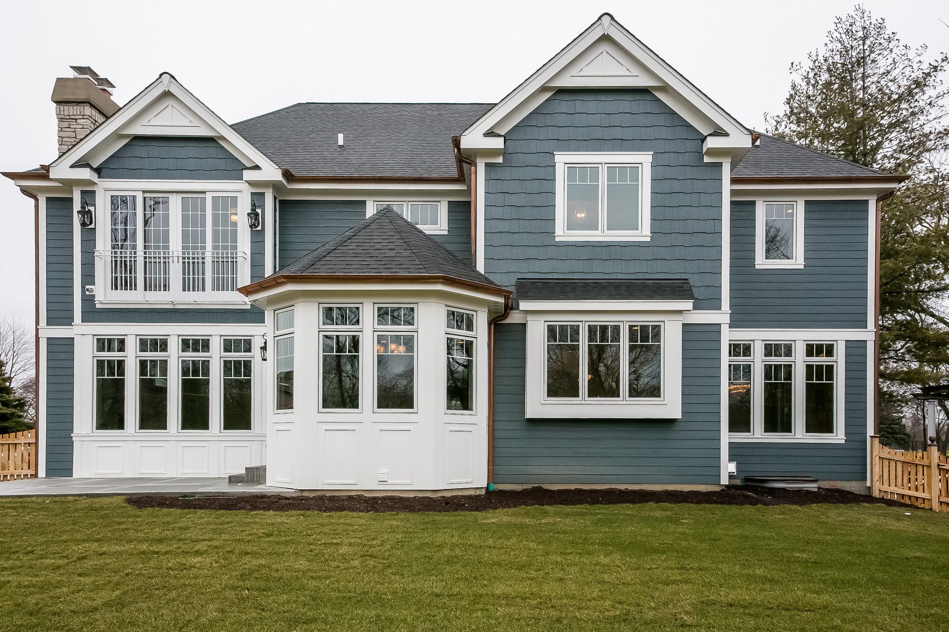 A large blue and white house with a lot of windows