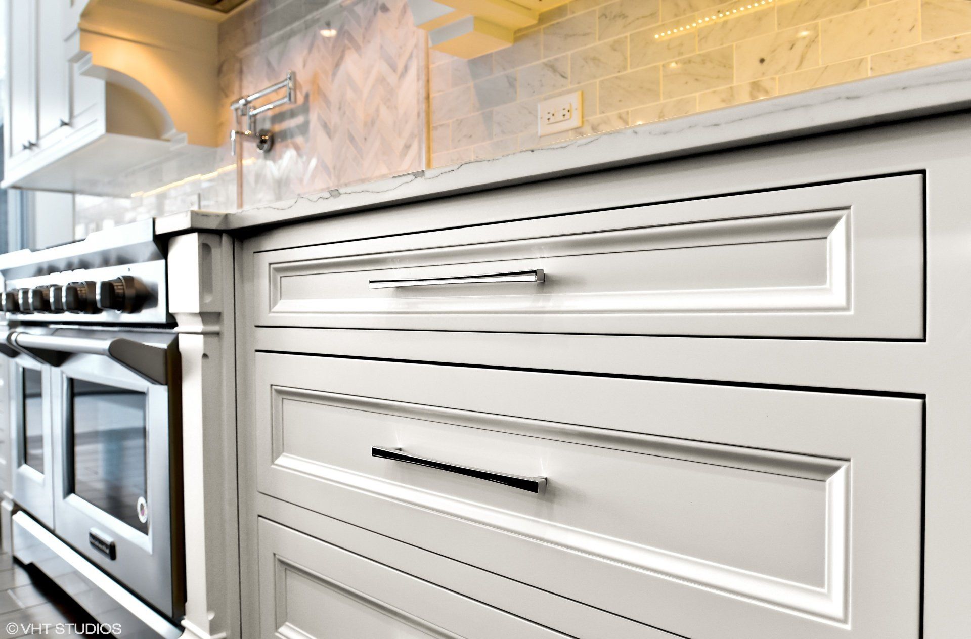 A kitchen with white cabinets and stainless steel appliances.