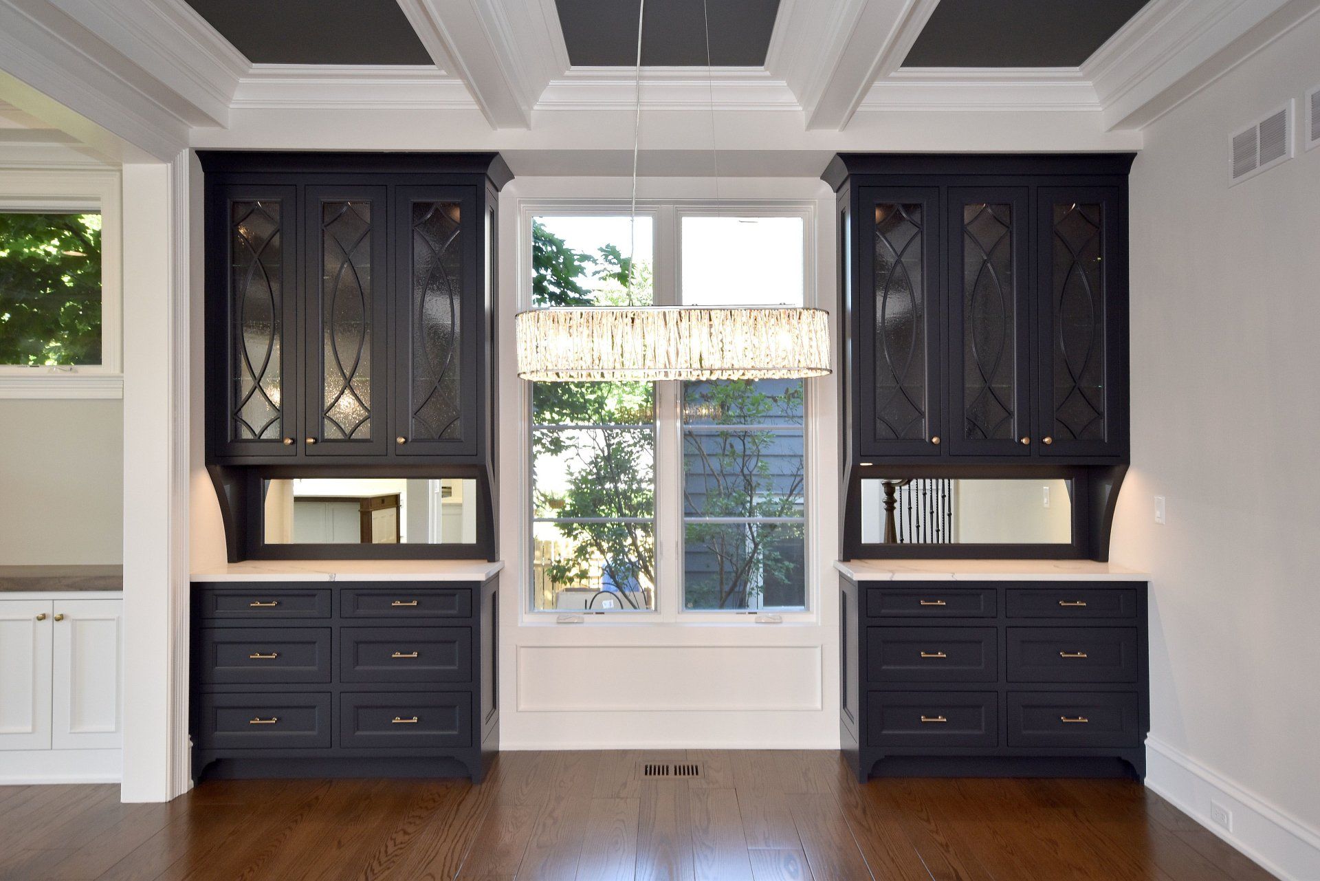 An empty room with black cabinets and a window