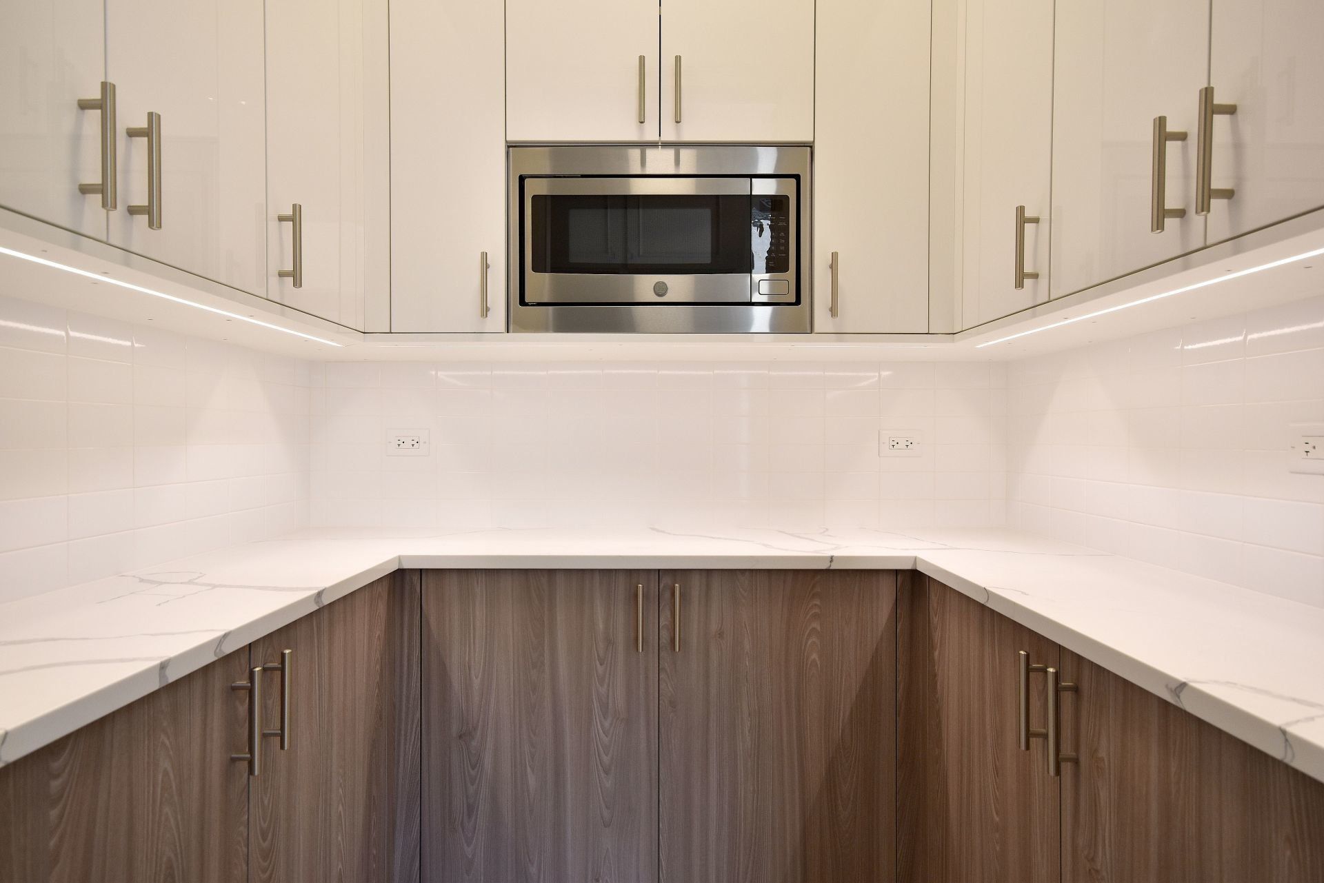 A kitchen with stainless steel appliances and wooden cabinets.